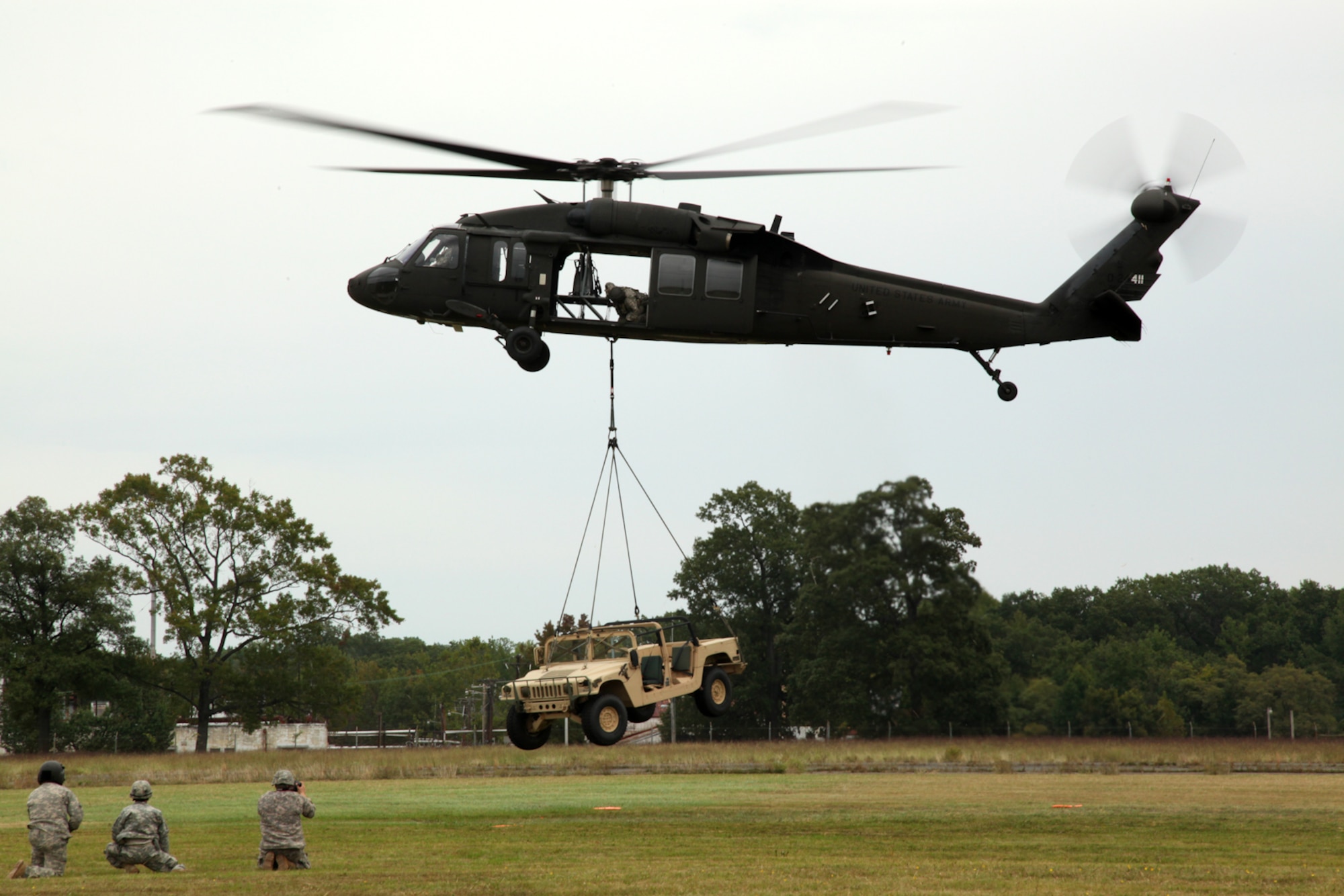 A UH-60 Black Hawk helicopter aircrew from C Company, 2-224 Aviation Battalion, sling loads a HMMWV above Weide Army Heliport as part of a joint air assault training exercise with the 175th Wing and the 55th Signal Company (Combat Camera) at Aberdeen Proving Ground, Md., on Sept. 29, 2010.  The Maryland National Guard conducted tactical passenger loading and external aerial delivery in preparation for overseas contingency operations and domestic response activities. Photo by U.S. Army Private First Class Alicia Brand, 55th Signal Company (Combat
Camera)

