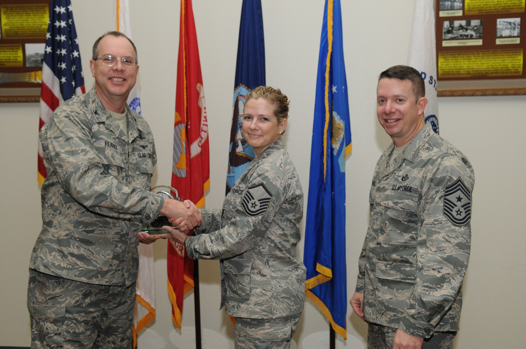 GOODFELLOW AIR FORCE BASE, Texas -- Master Sgt. Stephanie Barre, 17th Training Group, accepts her Senior Noncommissioned Officer of the Quarter Award for the third quarter from Col. David Rearick, 17th Training Wing Vice Commander, and Chief Master Sgt. Brendan Criswell, 17th TRW Command Chief, during the awards breakfast Oct. 26. (U.S. Air Force photo/Airman 1st Class Clayton Lenhardt)