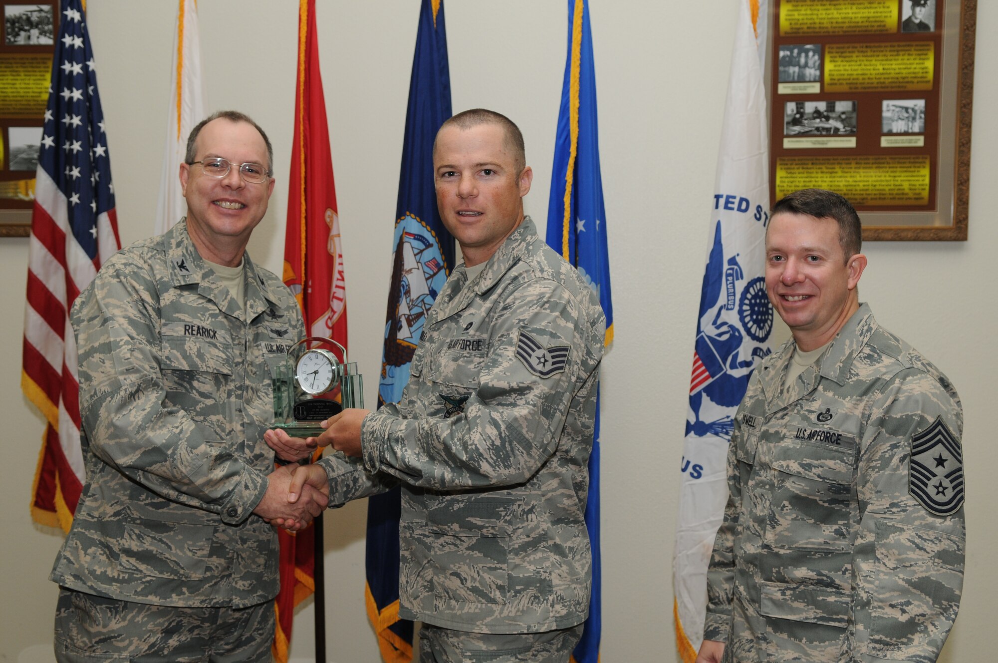 GOODFELLOW AIR FORCE BASE, Texas -- Staff Sgt. Anthony Fridley, 17th Training Group, accepts his Noncommissioned Officer of the Quarter Award for the third quadrter from Col. David Rearick, 17th Training Wing Vice Commander, and Chief Master Sgt. Brendan Criswell, 17th TRW Command Chief, during the awards breakfast Oct. 26. (U.S. Air Force photo/Airman 1st Class Clayton Lenhardt)