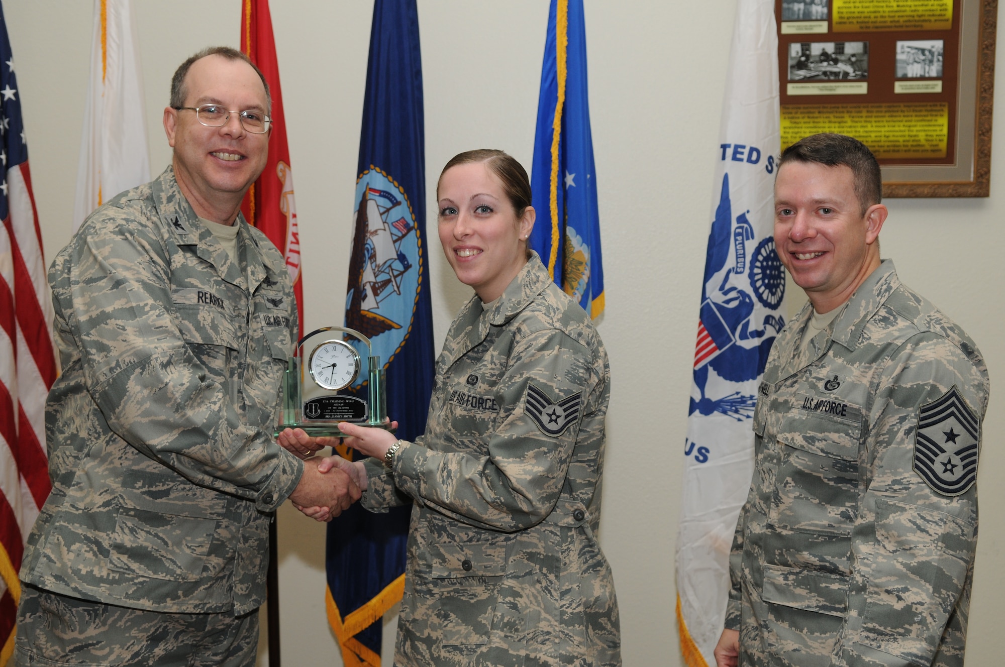 GOODFELLOW AIR FORCE BASE, Texas -- Senior Airman Jeanice Smith, 17th Training Group, accepts her Airman of the Quarter Award for the third quarter from Col. David Rearick, 17th Training Wing Vice Commander, and Chief Master Sgt. Brendan Criswell, 17th TRW Command Chief, during the awards breakfast Oct. 26. (U.S. Air Force photo/Airman 1st Class Clayton Lenhardt)