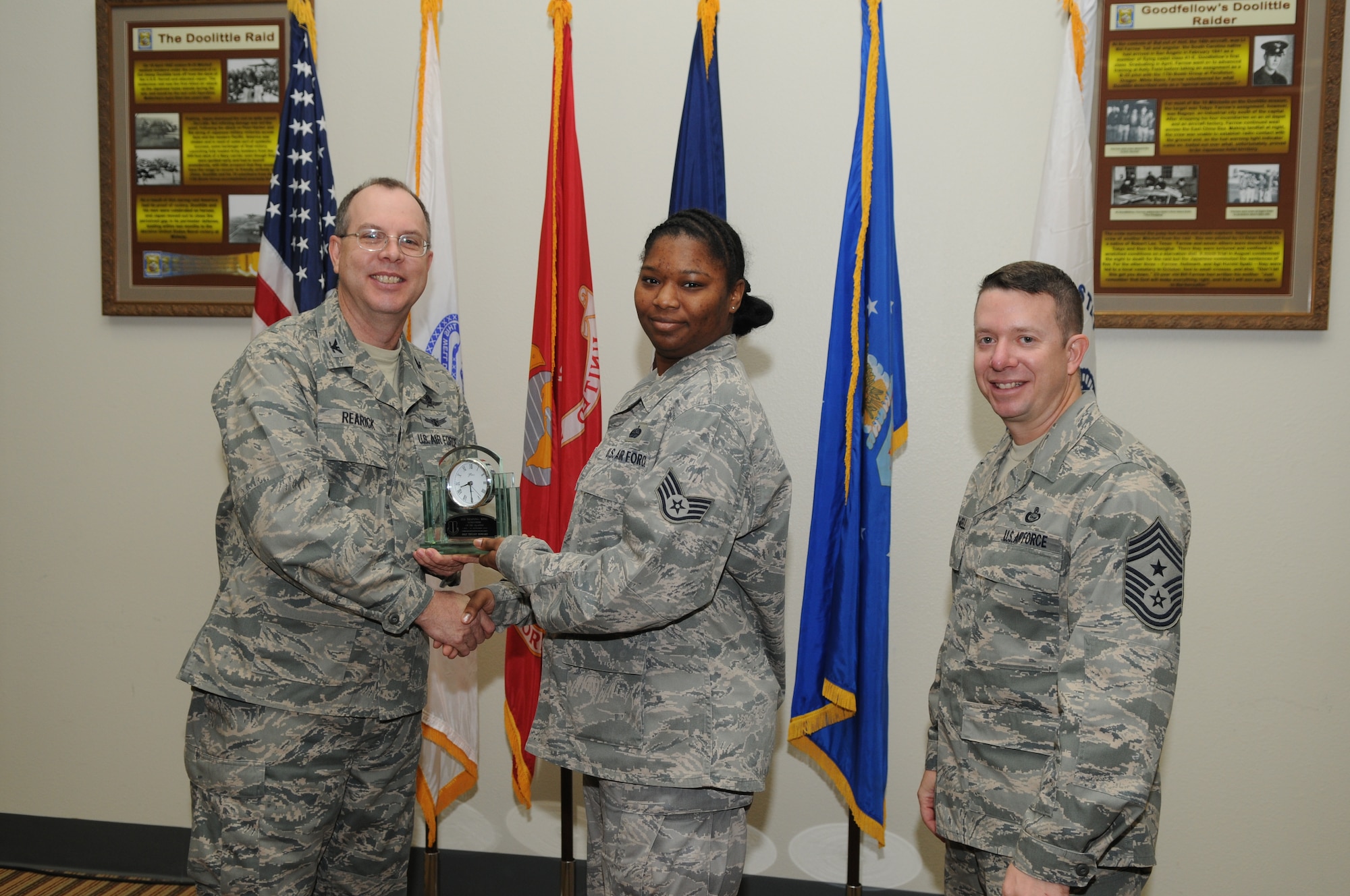 GOODFELLOW AIR FORCE BASE, Texas -- Staff Sgt. Tiffany Howard, 17th Mission Support Group, accepts her Volunteer of the Quarter award for the third quarter from Col. David Rearick, 17th Training Wing Vice Commander, and Chief Master Sgt. Brendan Criswell, 17th TRW Command Chief, during the awards breakfast Oct. 26. (U.S. Air Force photo/Airman 1st Class Clayton Lenhardt)