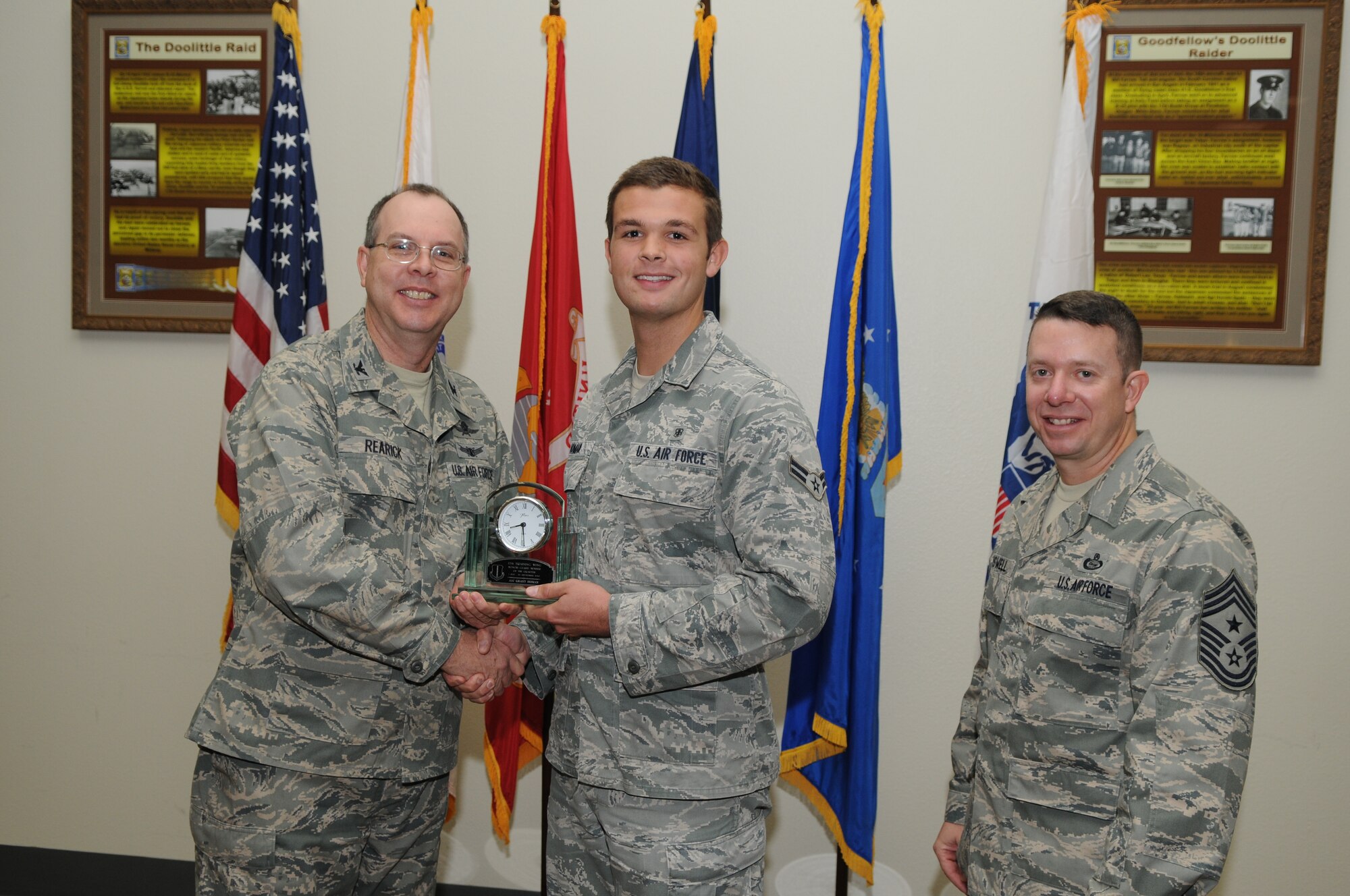 GOODFELLOW AIR FORCE BASE, Texas -- Airman 1st Class Grant Homan, 17th Medical Group, accepts his Honor Guard Member of the Quarter award for the third quarter from Col. David Rearick, 17th Training Wing Vice Commander, and Chief Master Sgt. Brendan Criswell, 17th TRW Command Chief, during the awards breakfast Oct. 26. (U.S. Air Force photo/Airman 1st Class Clayton Lenhardt)