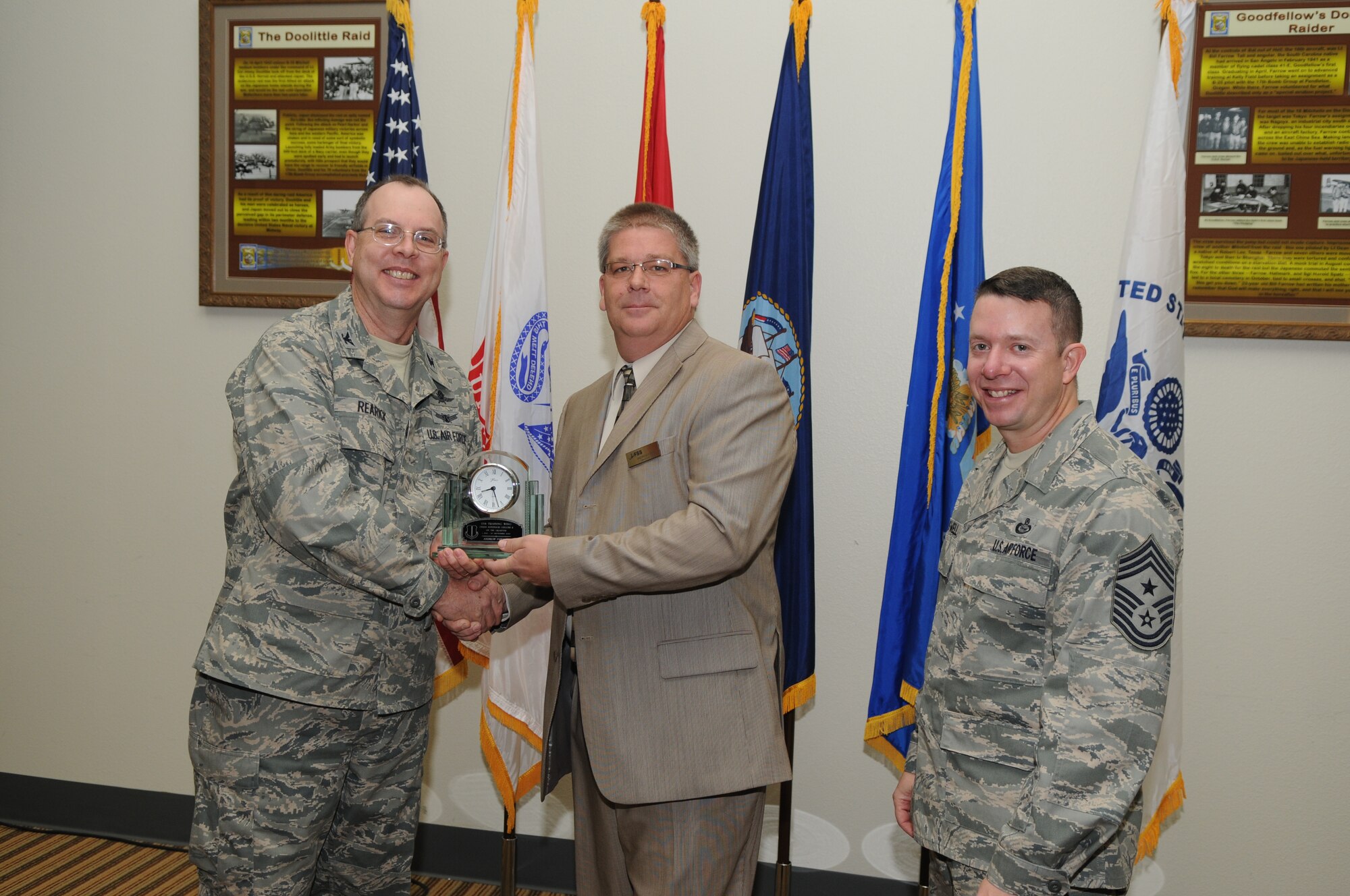 GOODFELLOW AIR FORCE BASE, Texas -- Andrew Furman, 17th Mission Support Group, accepts his Civilian of the Quarter Supervisor Category II award for the third quarter from Col. David Rearick, 17th Training Wing Vice Commander, and Chief Master Sgt. Brendan Criswell, 17th TRW Command Chief, during the awards breakfast Oct. 26. (U.S. Air Force photo/Airman 1st Class Clayton Lenhardt)