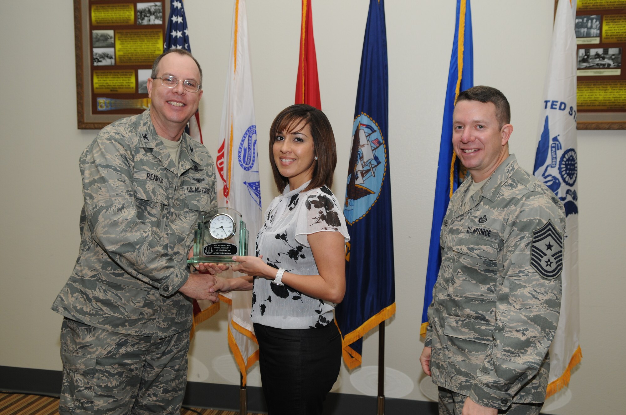 GOODFELLOW AIR FORCE BASE, Texas -- Denise Padilla-Rorie, 17th Training Group, accepts her Civilian of the Quarter Category II award for the third quarter from Col. David Rearick, 17th Training Wing Vice Commander, and Chief Master Sgt. Brendan Criswell, 17th TRW Command Chief, during the awards breakfast Oct. 26. (U.S. Air Force photo/Airman 1st Class Clayton Lenhardt)