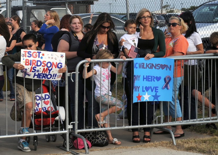 DYESS AIR FORCE BASE, Texas—Family members await the arrival of their loved ones Oct. 22 during a deployment return here. The 317 Aircraft Maintenance Squadron deployed in support of Operation Enduring Freedom, Operation New Dawn and Joint Task Force Horn of Africa. (U.S. Air Force photo/ Senior Airman Felicia Juenke)
