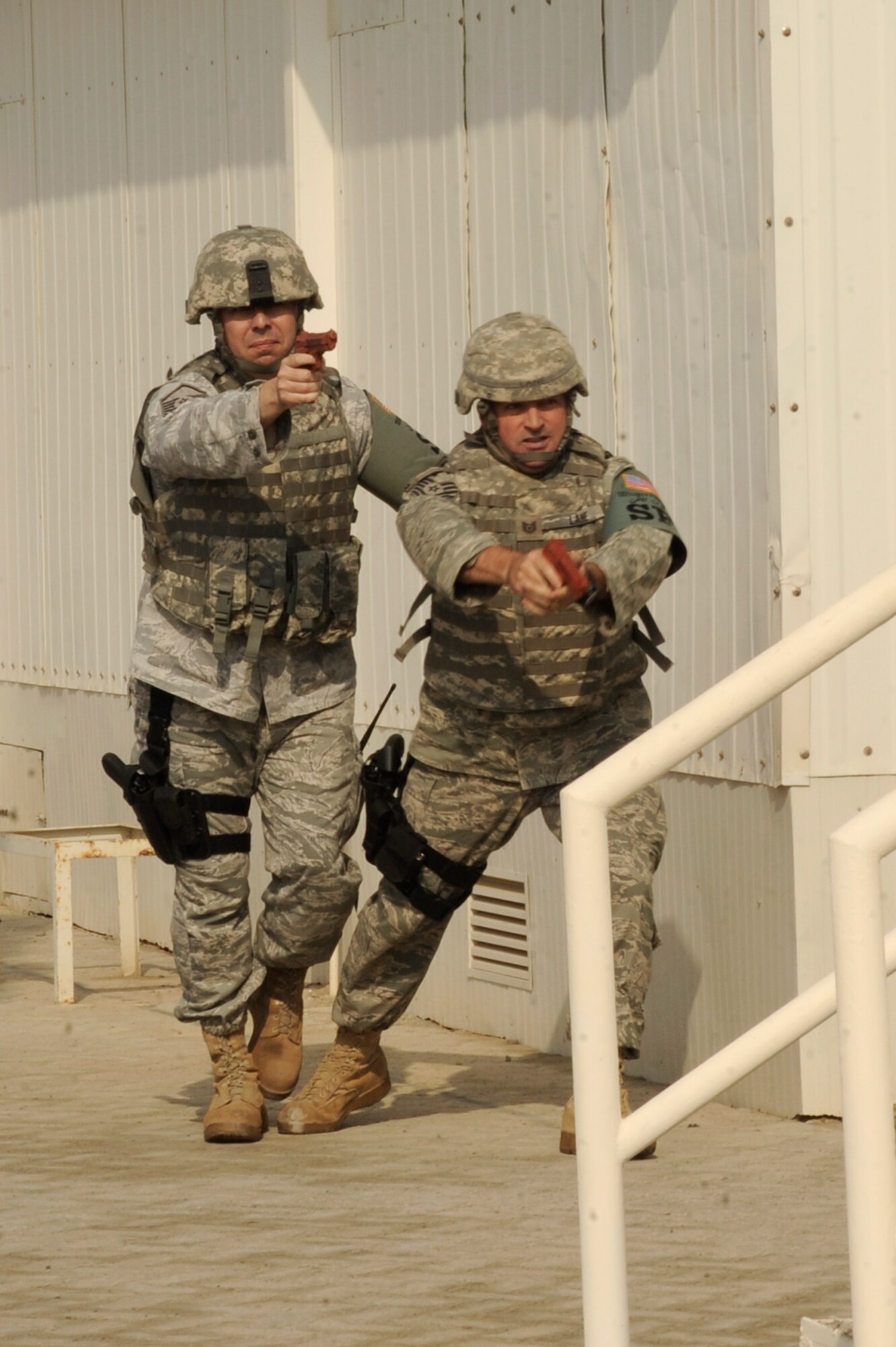 (Left) Master Sgt. Scott Sneddon, 380th Expeditionary Security Forces
Squadron flight chief, and Tech. Sgt. John Lane 380th ESFS security forces
craftsman, move to apprehend a simulated active shooter during an exercise
Oct. 23, 2010, at an undisclosed location in Southwest Asia. Airmen from the 380th Air Expeditionary Wing practiced how to respond to an active shooter during the exercise. (U.S. Air Force photo/Tech. Sgt. April Wickes) 
