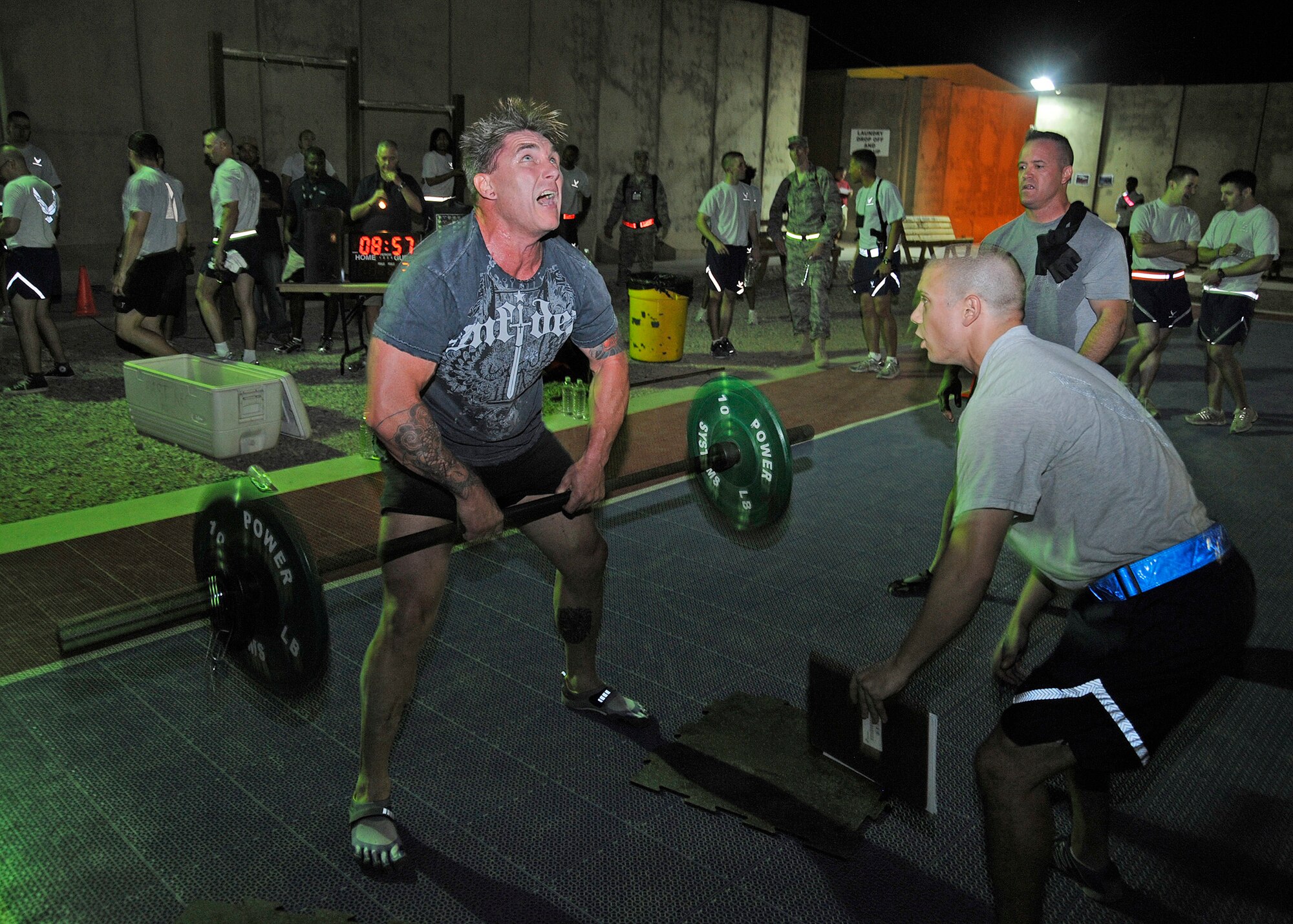 Steve Rombado, Military Welfare and Recreation Center manager, ups the intensity to complete as many repetitions as possible in one minute at the sumo dead lift station during the Cross Fit “Fight Gone Bad” Challenge Oct. 20, 2010, Joint Base Balad, Iraq. There are 10 areas of fitness that Cross Fit covers: cardiovascular/respiratory endurance, stamina, strength, flexibility, power, speed, agility, balance, coordination and accuracy.  Mr. Rombado is a native of Houston, Texas. (U.S. Air Force photo/ Senior Airman Matt Coleman-Foster)