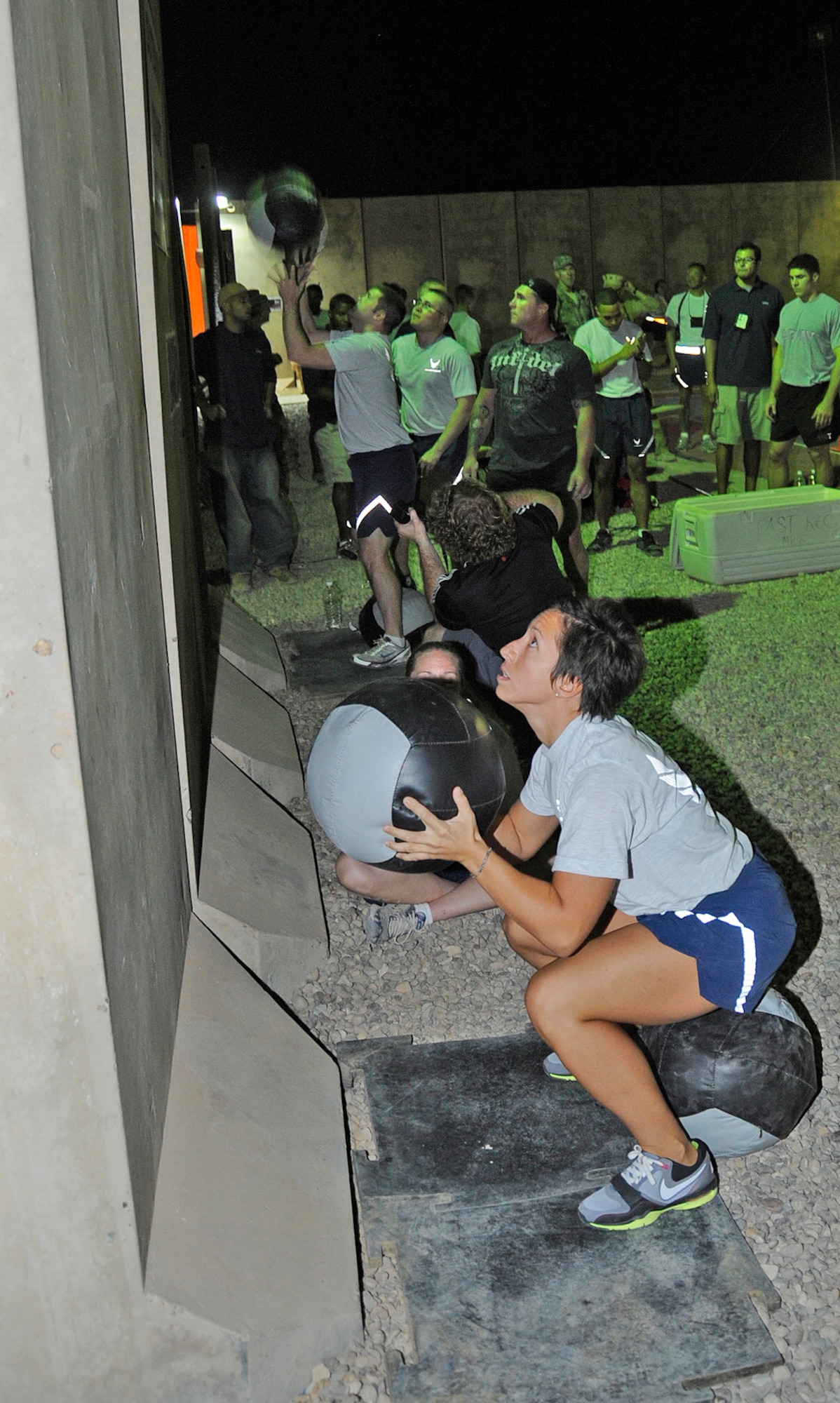 Tech. Sgt. Kristin Dobson, 332nd Expeditionary Operation Support Squadron Air Traffic Control watch supervisor, works out her quadriceps and calf muscles at the wall ball station during the Cross Fit “Fight Gone Bad” Challenge Oct. 20, 2010, Joint Base Balad, Iraq. Cross Fit is just one of many fitness classes available at fitness centers in deployed locations and home stations. Sergeant Dobson, a native of Matthews County, Va., is deployed from Royal Air Force Lakenheath, England. (U.S. Air Force photo/ Senior Airman Matt Coleman-Foster)