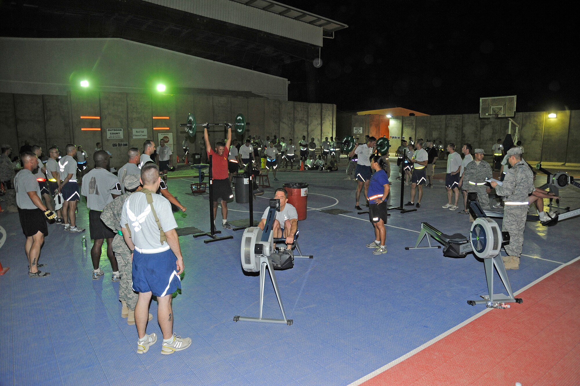 Military members and civilians participated in the Cross Fit “Fight Gone Bad” Challenge at the Tuskegee Fitness Center’s basketball courts Oct. 20, 2010, Joint Base Balad, Iraq. The challenge consisted of three one-minute rounds at five workout stations: wall ball, sumo dead lift high pull, box jumps, push press and rowing. (U.S. Air Force photo/ Senior Airman Matt Coleman-Foster)