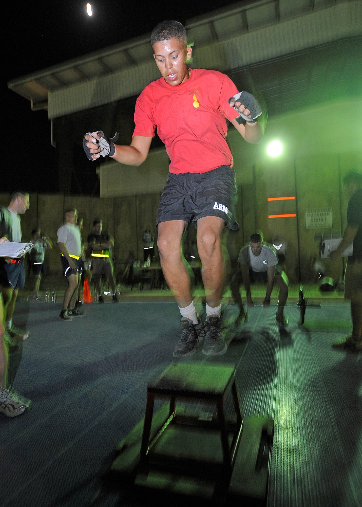 Army Private 1st Class Thomas Jefferson, 16th Ordnance Company wheeled vehicle mechanic, pushes himself to complete as many repetitions as he can in one minute at the box jump station during the Cross Fit “Fight Gone Bad” Challenge Oct. 20, 2010, Joint Base Balad, Iraq. The challenge consisted of three one-minute rounds at five workout stations: wall ball, sumo dead lift high pull, box jumps, push press, and rowing. Private Jefferson is a native of Columbus, Ohio, deployed from Fort Carson, Colo. (U.S. Air Force photo/ Senior Airman Matt Coleman-Foster)