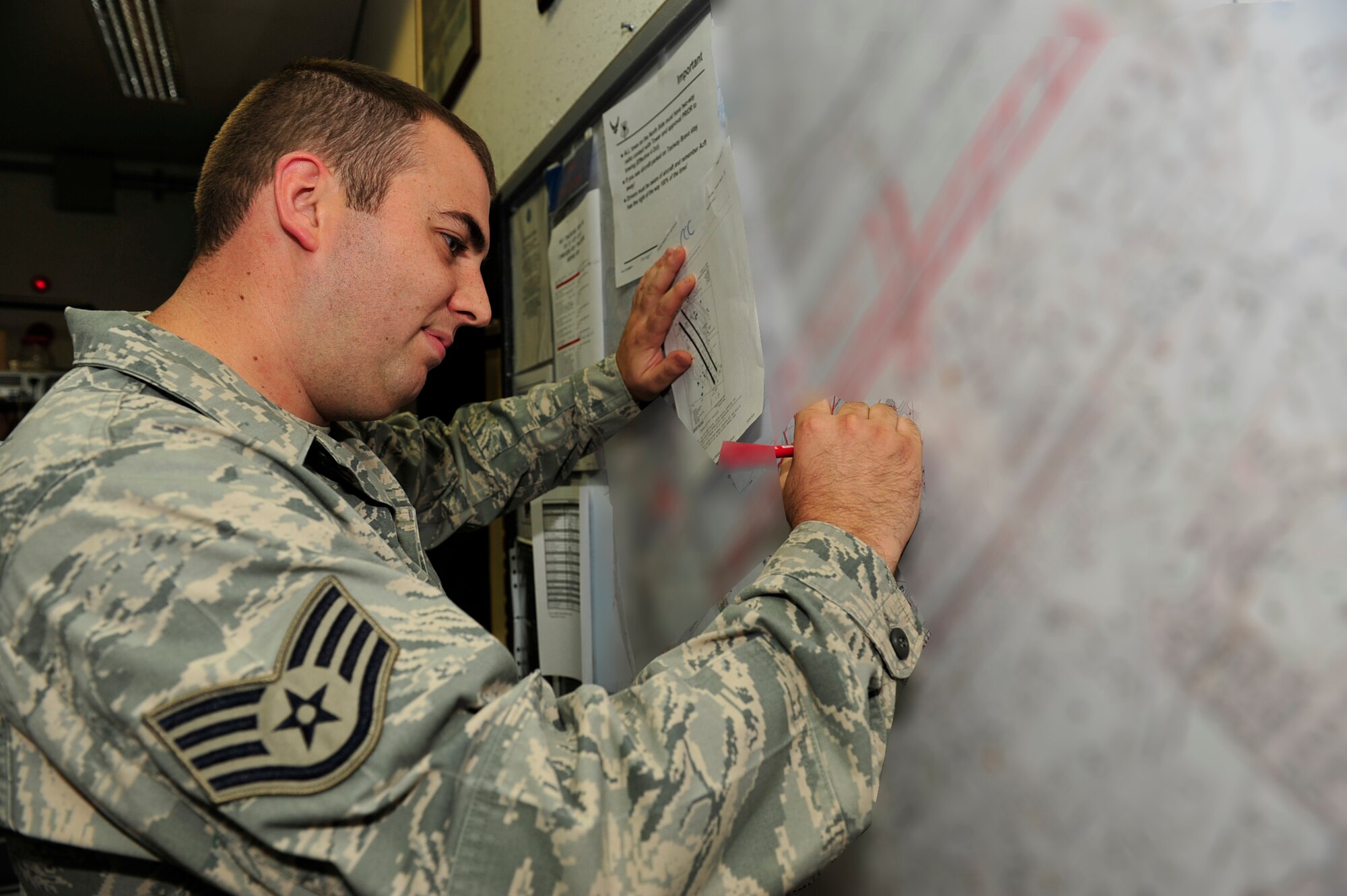 Staff Sgt Christopher Fry, a weapons system coordinator for the 18th  Maintenance Operations Center (MOC)  checks the airfield NOTAMS  during the Beverly High 11-01 exercise here at Kadena Air Base. Members of the MOC mission is to coordinate between the flight line agencies. ( U.S. Air Force photo/ Staff Sgt. Lakisha A.Croley 