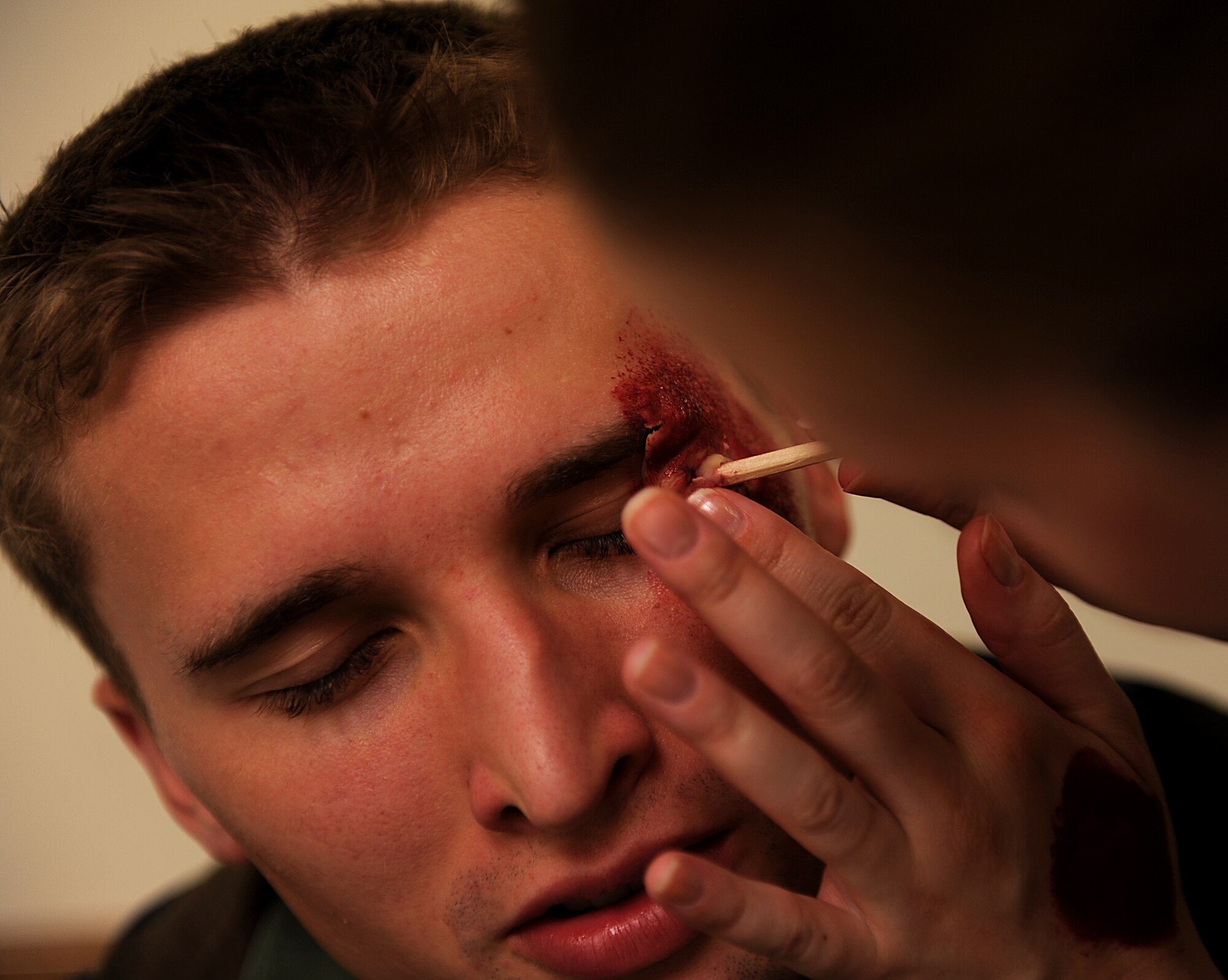 Staff Sgt. Cynthia Evans from the 18th Dental Squadron applies moulage to Airman 1st Class Harrison Hayes, 961st Airborne Air Control Squadron during an exercise Oct. 25. Moulage is used to simulate severe personnel injuries, adding a heightened degree of reality to emergency situations. Kadena personnel are participating in Exercise Beverly High 11-01 to stay prepared for real world contingencies. (U.S. Air Force photo/Staff Sgt. Christopher Hummel)
