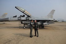 KWANGJU AIR BASE, Republic of Korea -- Brig. Gen. Jung Jae-Boo, Republic of Korea Air Force Operations Center deputy commander, and Brig. Gen. Scott Dennis, 7th Air Force vice commander, congratulate each other after a successful flight Oct. 21 in support of exercise Max Thunder 10-02. More than 170 Wolf Pack Airmen participated in the fourth annual exercise at Kwangju Air Base Oct. 15-22. (U.S. Air Force photo/Master Sgt. Jason Wilkerson)