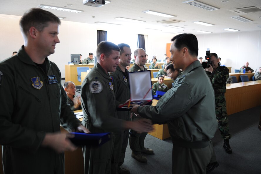 KWANGJU AIR BASE, Republic of Korea -- Lt. Col. David Shoemaker, 35th Fighter Squadron director of operations, and Lt. Col. James Wilkerson, 80th Fighter Squadron commander, accept a gesture of thanks from Brig. Gen. Jung Jae-Boo, Republic of Korea Air Force Operations Center deputy commander, for their participation in exercise Max Thunder 10-02. More than 170 Wolf Pack Airmen participated in the fourth annual exercise at Kwangju Air Base Oct. 15-22. (U.S. Air Force photo/Master Sgt. Jason Wilkerson)