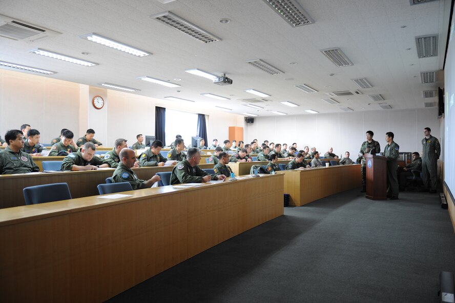 KWANGJU AIR BASE, Republic of Korea -- Participants in the 2010 Max Thunder exercise listen to a pre-flight briefing before takeoff Oct. 21. More than 170 Wolf Pack Airmen participated in the fourth annual exercise at Kwangju Air Base Oct. 15-22. (U.S. Air Force photo/Master Sgt. Jason Wilkerson)