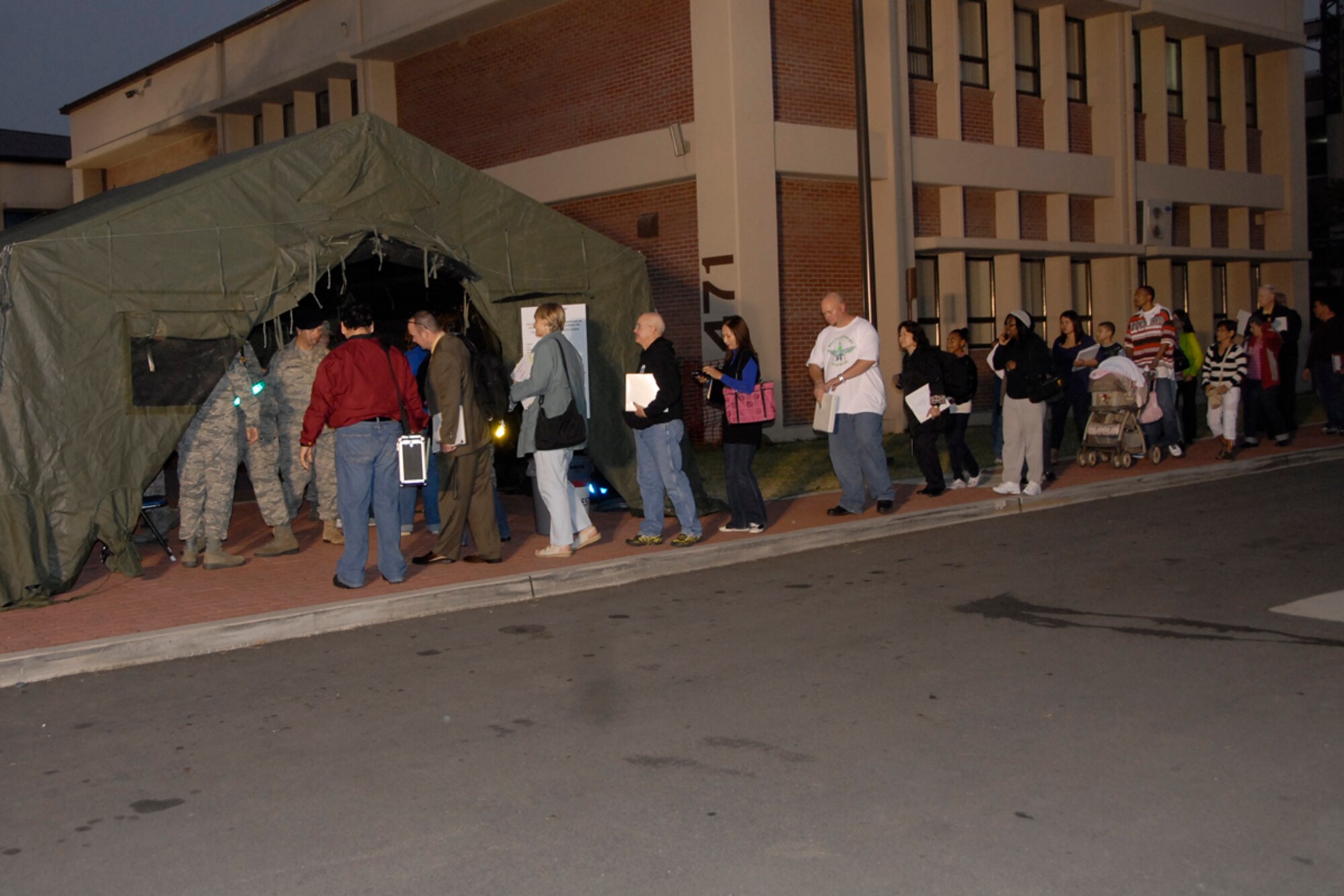 Non-combatants proceed through a processing line at Osan Air Base, Republic of Korea Oct. 22. The line was apart of an annual Non-combatant Evacuation Operation exercise. The two-day exercise tested the base's ability to process and evacuate non-combatant base personnel and dependants in the event of an emergency. (U.S. Air Force photo/Staff Sgt. Eunique Stevens)   