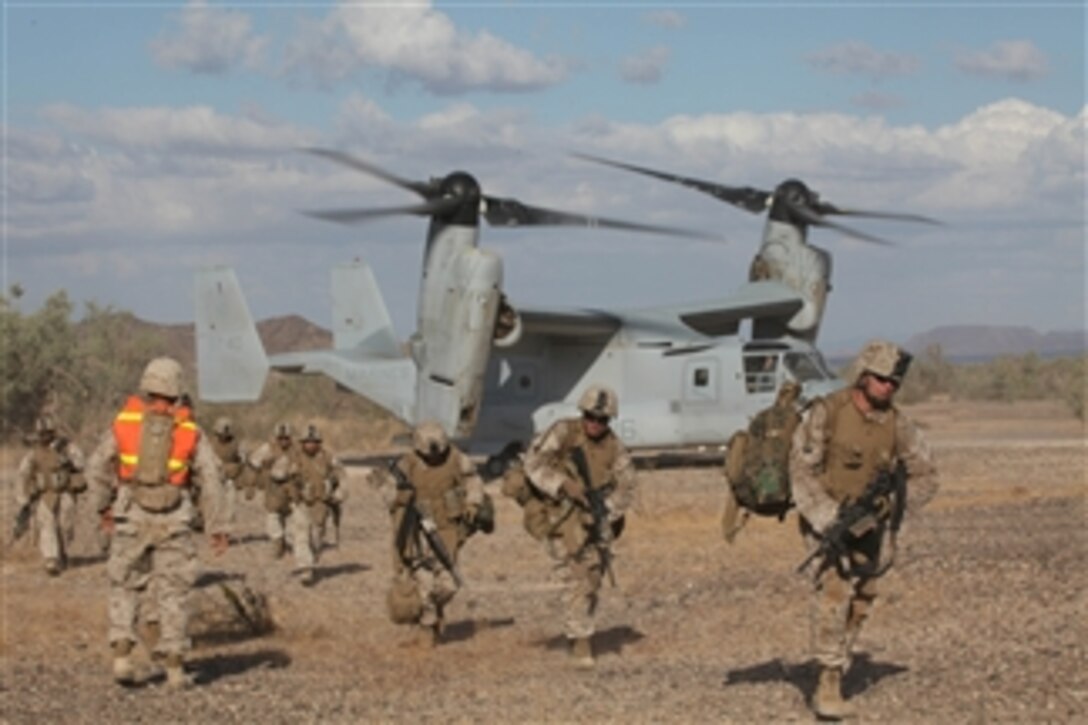 U.S. Marines with Second Battalion, Seventh Marine Division unload from a U.S. Marine MV-22 Osprey in Landing Zone Crow in the Imperial Desert, Calif., on Oct. 18, 2010.  The Marines are participating in the Assault Support Tactics One exercise in support of Marine Aviation Weapons and Tactics Instructor's Course 1-11 hosted by Marine Aviation Weapons and Tactics Squadron One.  
