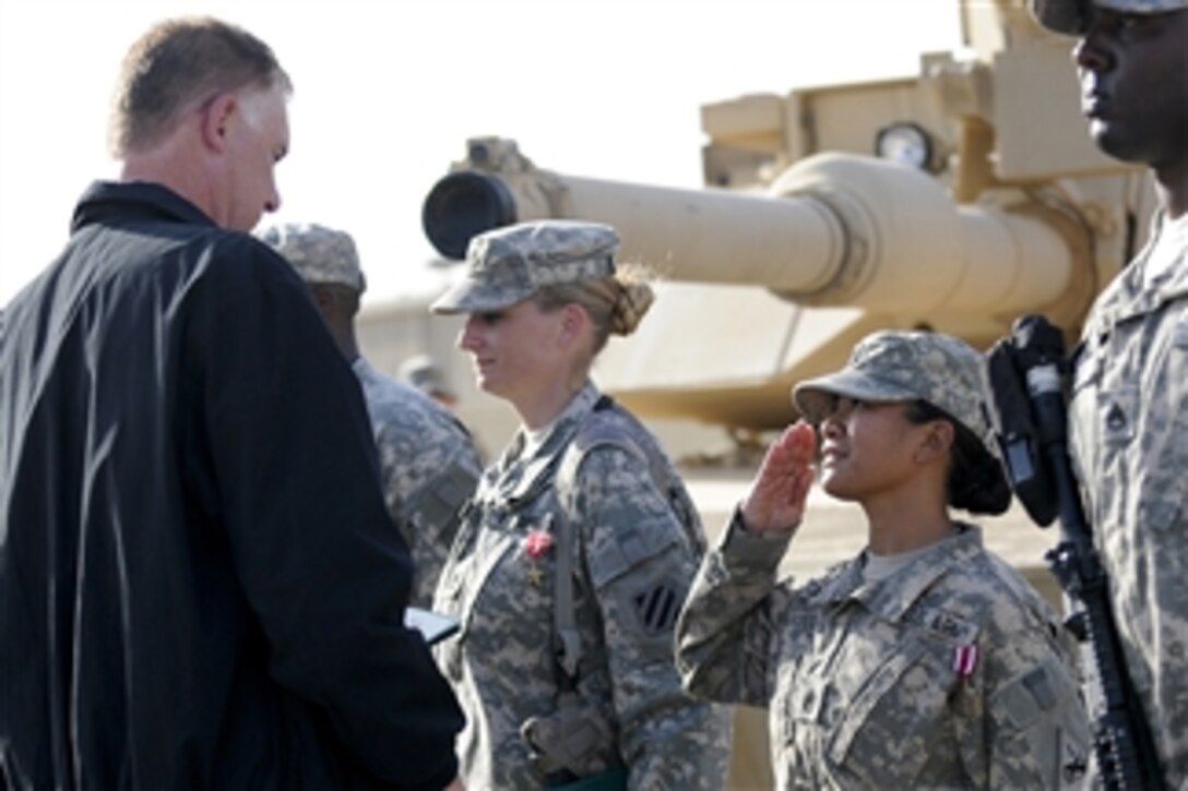 Deputy Secretary of Defense William J. Lynn III presents awards to U.S. Army soldiers in Baghdad, Iraq, on Oct. 26, 2010.  