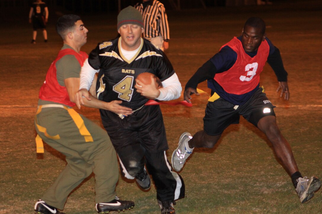 Bats quarterback Jason Bennett goes for a quarterback rush against the IYAOYAS during a 2010 Intramural Flag Football Season game at the Penny Lake football field here Oct. 27. While the Bats held the IYAOYAS to only one touchdown in the first half, the Bats players were unable to put any points up of their own.