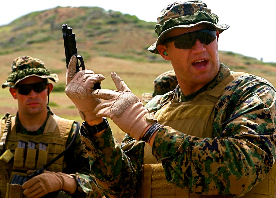 Marines of 2nd Platoon, Force Reconnaissance Company, II Marine Expeditionary Force, receive instruction on the proper way to conduct immediate action drills with the M9 pistol Oct. 22, 2010. The Marines spent three days practicing marksmanship with the M4 carbine, the M240 squad automatic weapon, the M9-A1 pistol, the M107 special applications scoped rifle and the M40-A5 sniper rifle.