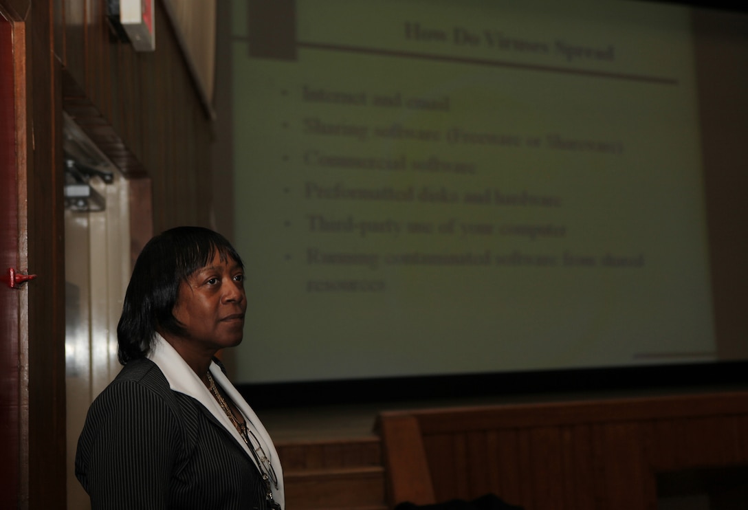 Carolyn B. Harrison, the information assurance manager for Marine Corps Base Camp Lejeune, listens to a question about computer viruses during an information assurance training class at the base theater, recently.  Professional information technicians with MCB Camp Lejeune take proactive measures to safeguard against violators, and to disseminate, educate and train everyone who works and lives aboard the base about information assurance.