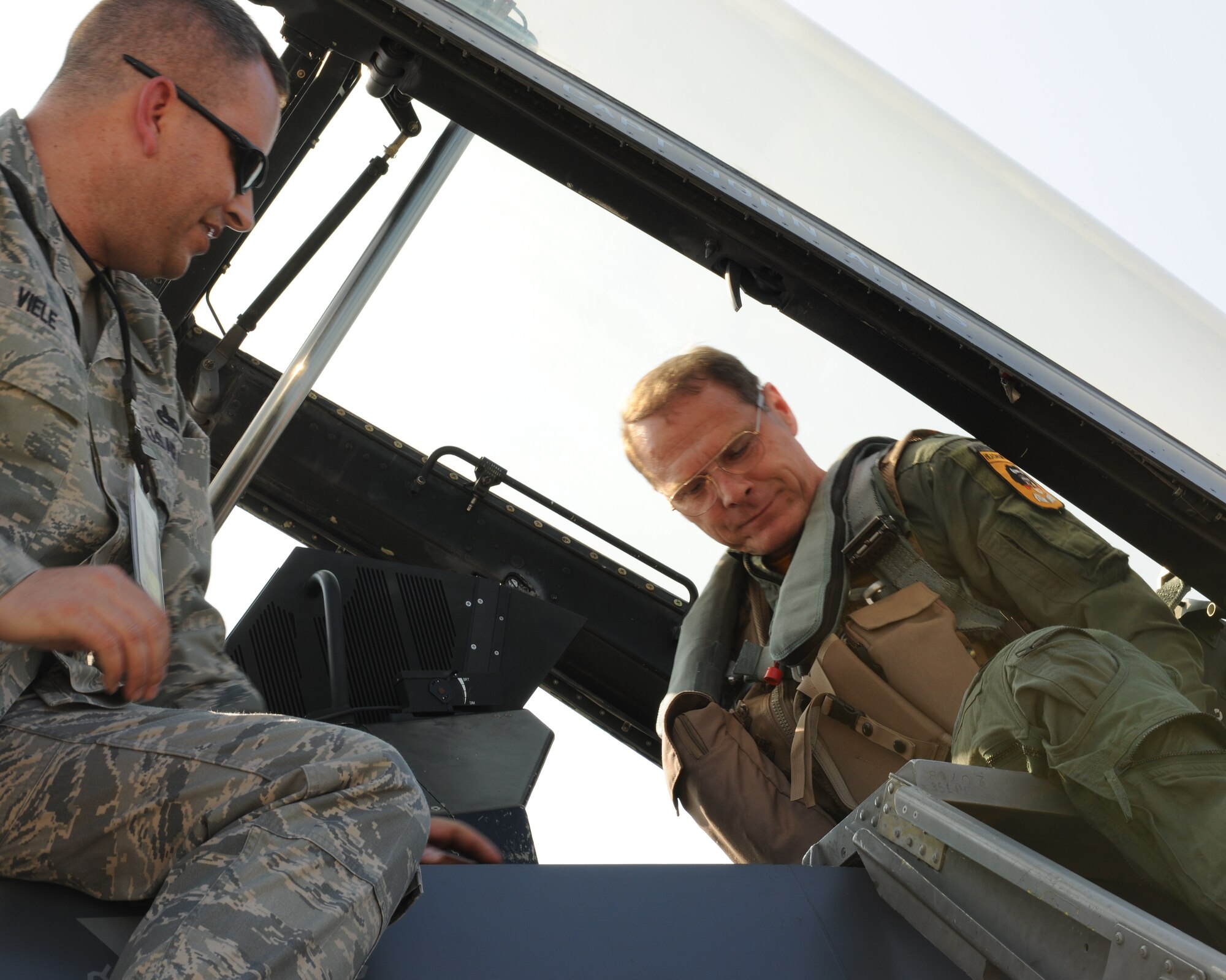 KUNSAN AIR BASE, Republic of Korea -- Master Sgt. Gene Viele, 8th Aircraft Maintenance Squadron, helps Army Maj. Gen. John MacDonald, U.S. Forces Korea CJ3, into an F-16 Fighting Falcon here Oct. 22. General MacDonald visited the 8th Fighter Wing for an orientation flight to see how the Wolf Pack provides close air support to operational Army assets on the ground in the Republic of Korea. (U.S. Air Force photo/Senior Airman Ciara Wymbs)