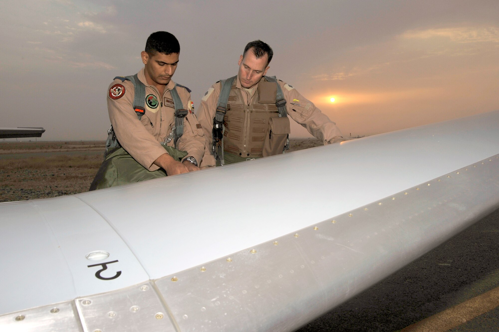Lt. Col. Charles Stevens goes over the pre-flight check list with an Iraqi air force student pilot Sept. 26, 2010, at Tikrit Air Base, Iraq. U.S. Air Force instructor pilots are training and advising the first group of Iraqi air force instructor pilots on the T-6A Texan II as part of the advise, train, assist and equip mission of Operation New Dawn. Once qualified, the Iraqi air force pilots will become instructor pilots and continue to train the next generation of pilots. Colonel Stevens is the 52nd Expeditionary Flying Training Squadron commander. (U.S. Air Force photo/Senior Airman Perry Aston) 
