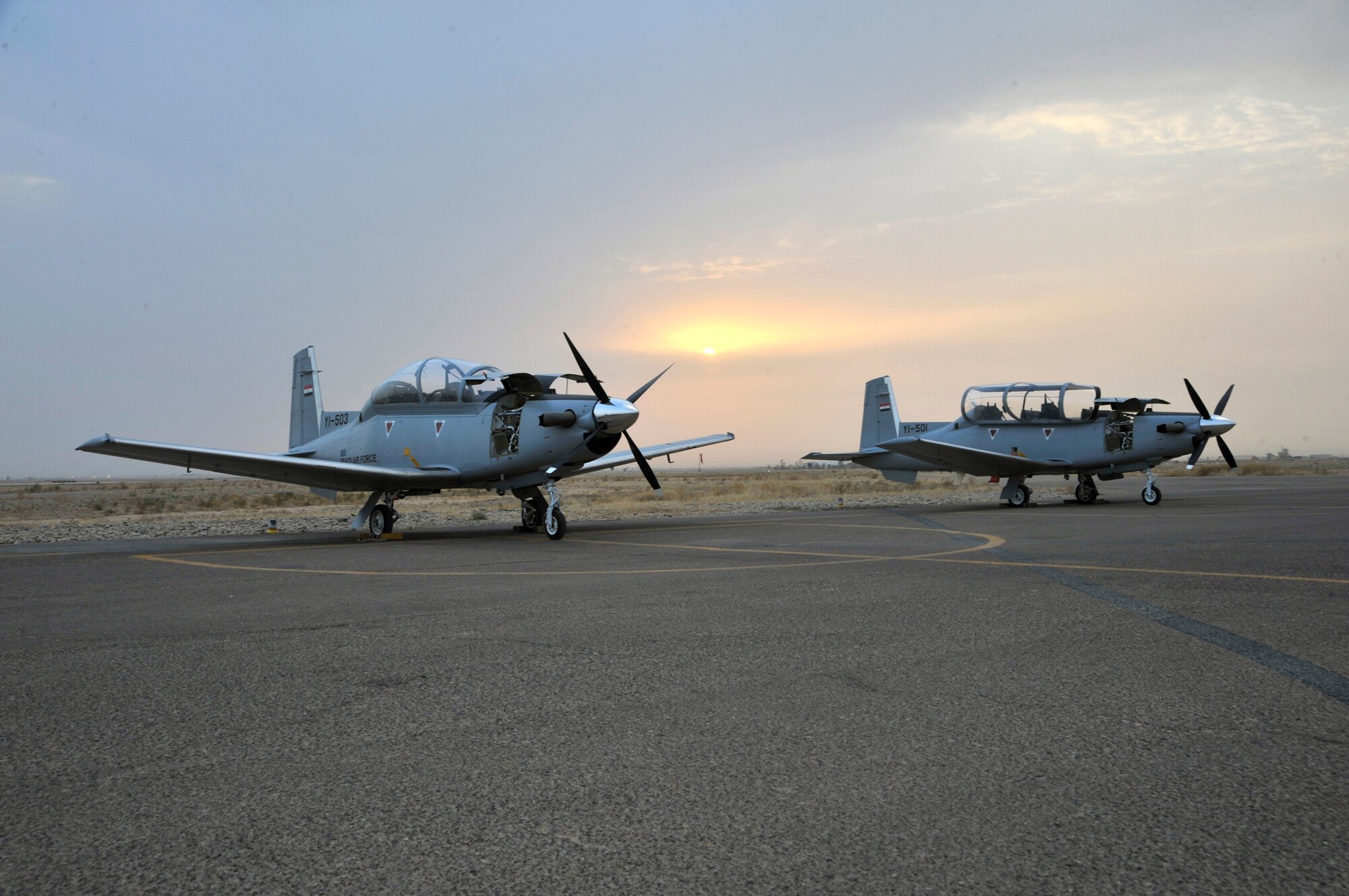 Iraqi air force T-6 Texan IIs sit on the flight line Sept. 26, 2010, at Tikrit Air Base, Iraq. Instructor pilots from the 52nd Expeditionary Flying Training Squadron are training and advising the first group of Iraqi air force instructor pilots on the T-6A Texan II as part of the advise, train, assist and equip mission of Operation New Dawn. Once qualified, the Iraqi air force pilots will become instructor pilots and continue to train the next generation of pilots. (U.S. Air Force photo/Senior Airman Perry Aston)