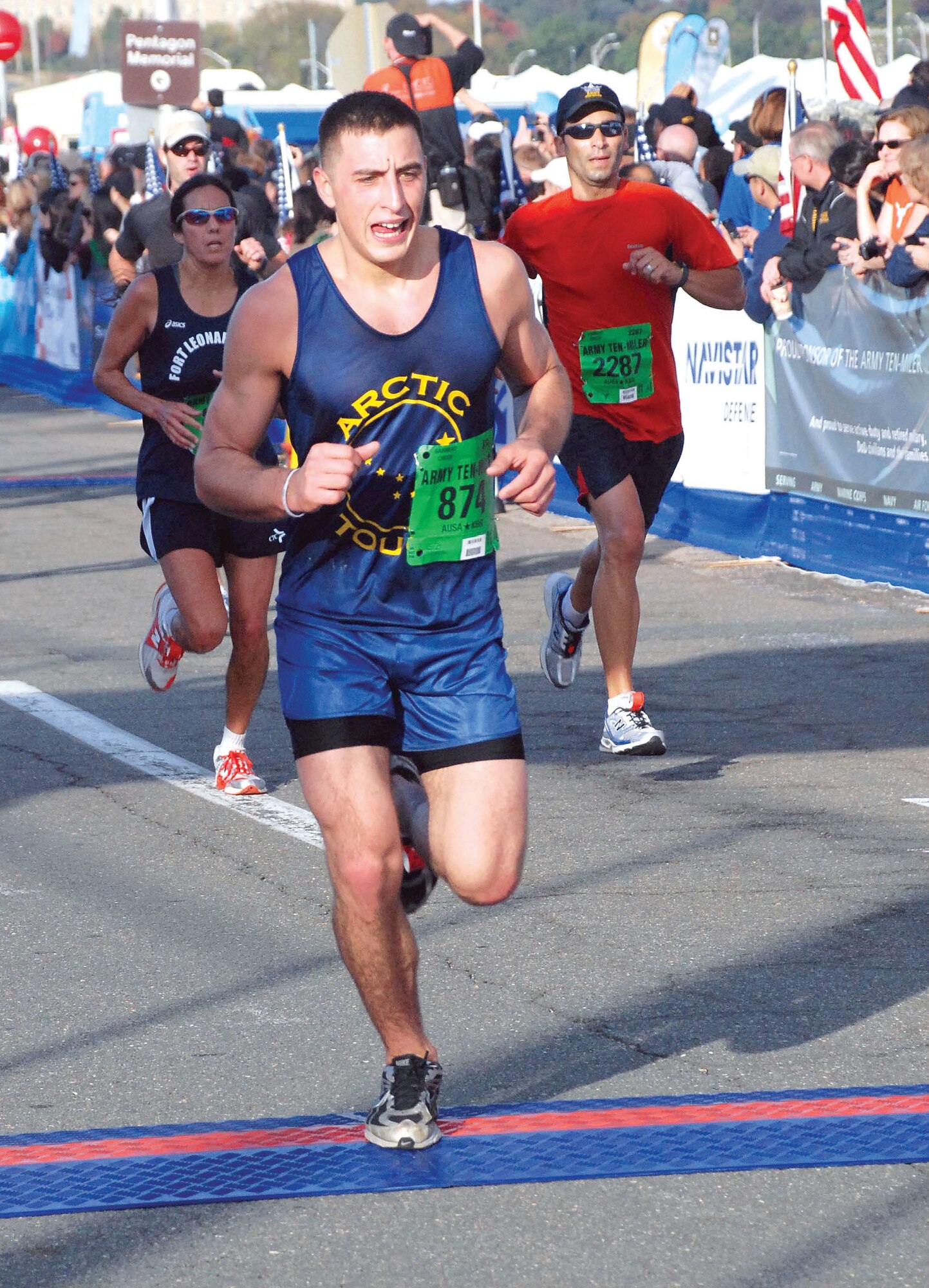 Dominic Bruce, 846th Engineer Support Company, 3rd Maneuver Enhancment Brigade, runs across the finish line of the 26th annual Army Ten-Miler in Washington, D.C., Sunday. More than 30,000 participants from throughout the world took to the course, which wound its way past many of the city’s most historic monuments. (U.S. Army photo/Mary M. Rall)