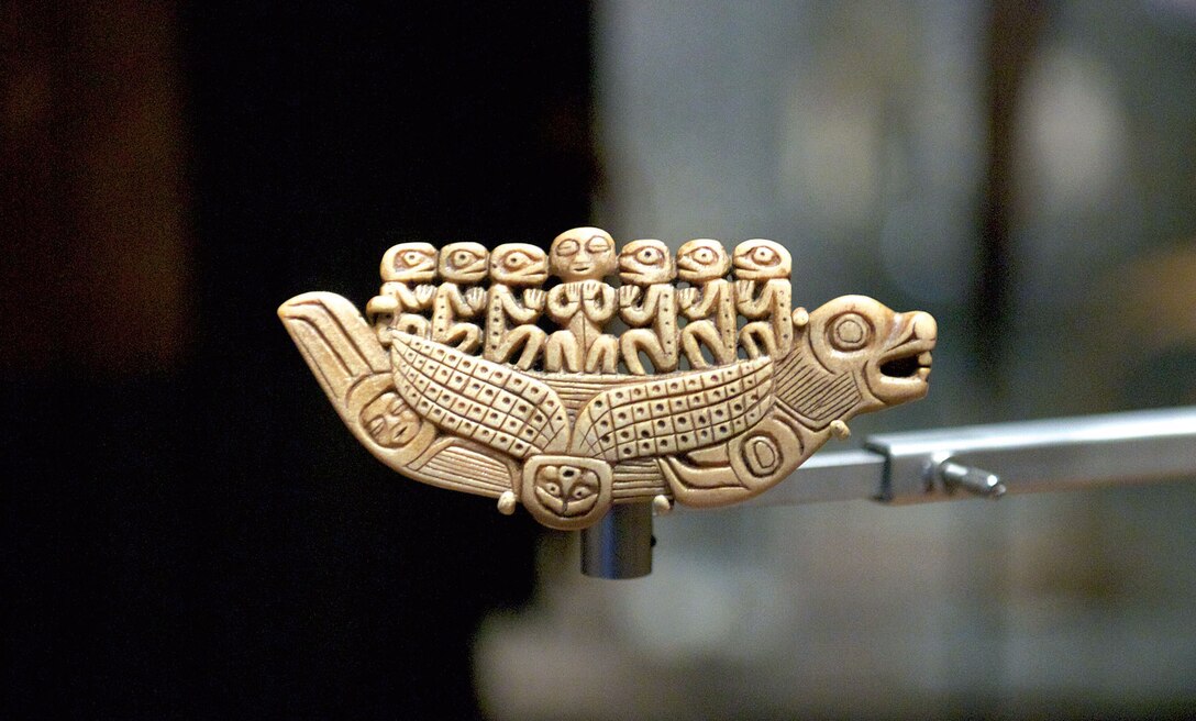 A tiny Tlingit sakaat shama’s amulet, shaped like a sea lion canoe in which seven spirits ride, is displayed in a Smithsonian Arctic Studies Center exhibition. The SASC features artifacts from all major Alaska Native groups. (U.S. Air Force photo/David Bedard)