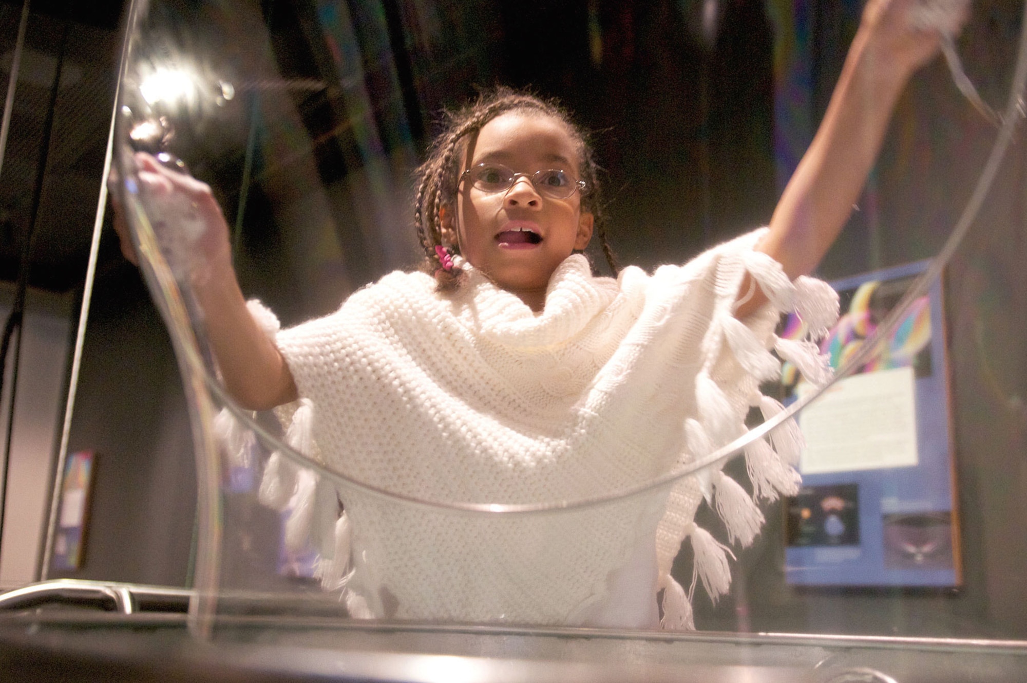 Jaida Carazo, 9, daughter of 2nd Lt. Edmund Carazo, 1st Battalion, 501st Infantry Regiment (Airborne), makes oversize bubbles at the Imaginarium Discovery Center, Oct. 14. The IDC offers learning activities and exhibitions for all ages. (U.S. Air Force photo/David Bedard)