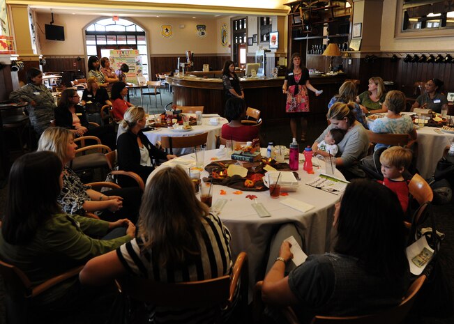 Teresa Givens, a member of the Team Charleston Spouses' Club, outlines the activities and topics that will be covered during the monthly gathering at the Charleston Club Oct. 26, 2010, on Joint Base Charleston-Air Base, S.C. The spouses' club offers many different clubs within itself from bunco, golf, movie nights, arts and crafts and creative cooking. One big project the club is working on is the annual cookie drop. The cookie drop allows spouses to cook batches of cookies to be given to Airmen throughout Joint Base Charleston and flown downrange during the holidays. (U.S. Air Force photo/Senior Airman Timothy Taylor)