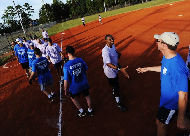 Chiefs, first sergeants and commanders line up to shake hands and high-five one another after a good game at the base softball field Oct. 26, 2010, on Joint Base Charleston, S.C. The chiefs and first shirts defeated the commanders 15-7 after seven innings. (U.S. Air Force photo/Senior Airman Timothy Taylor)
