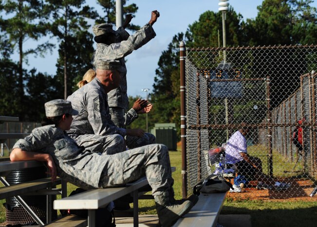 Airmen cheer as the chiefs/first sergeants battle against commanders in a game of softball at the base softball field Oct. 26, 2010 on Joint Base Charleston, S.C. The chiefs and first shirts defeated the commanders 15-7 after seven innings. (U.S. Air Force photo/Senior Airman Timothy Taylor)