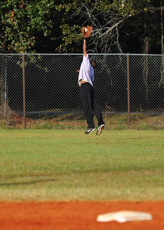 Master Sgt. Harley Davis makes a leaping catch at the top of the sixth inning during the chiefs and first shirts versus commanders softball game Oct. 26, 2010 on Joint Base Charleston, S.C. The chiefs and first shirts defeated the commanders 15-7 after seven innings. Sergeant Davis is the first sergeant for the wing staff agencies. (U.S. Air Force photo/Senior Airman Timothy Taylor)