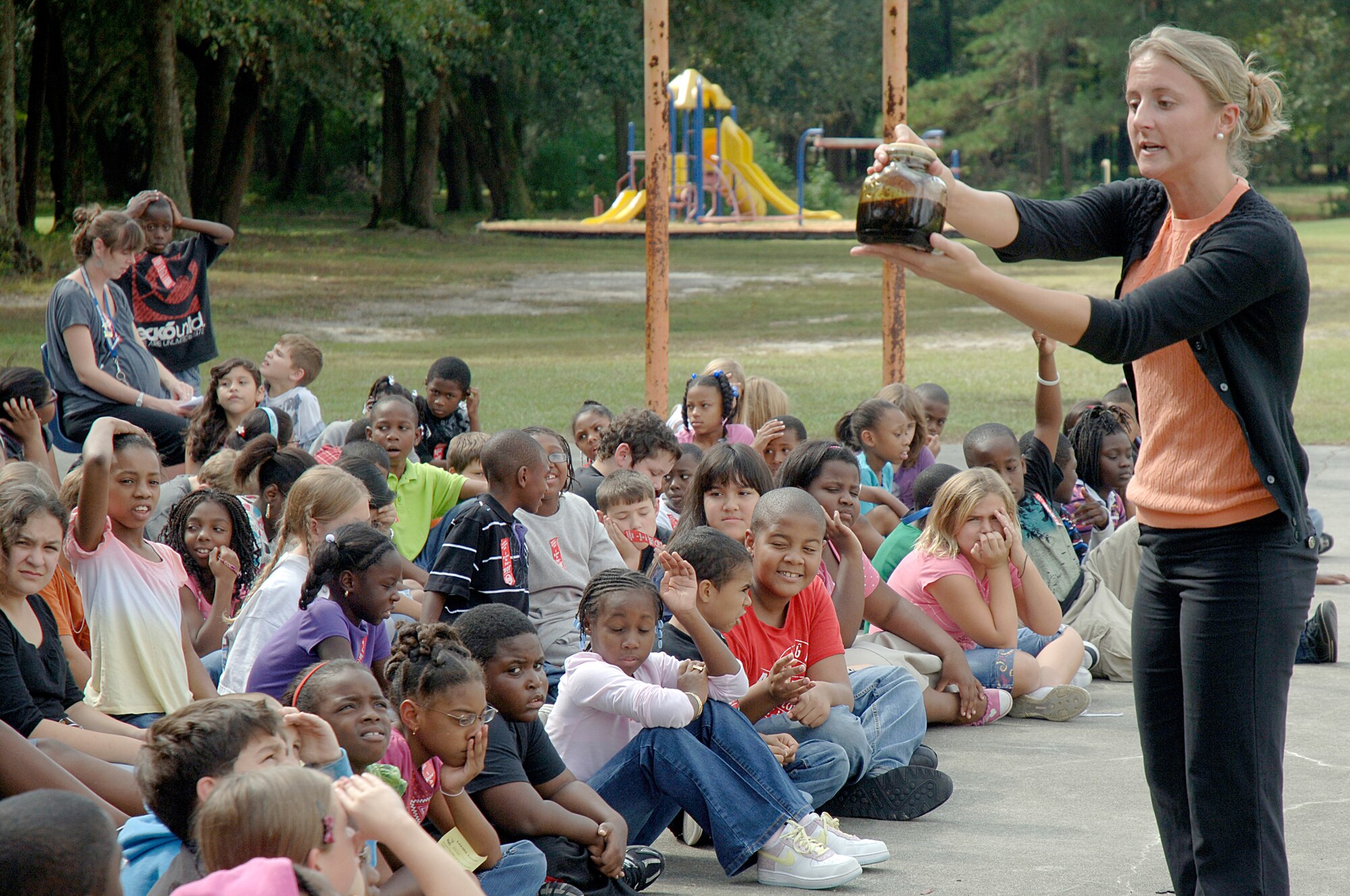 Ashley DeStefano shows students and faculty at Lambs Elementary School a jar of tar as she talks to them about the effects of tobacco use during Red Ribbon Week Oct. 26, 2010. Members of Joint Base Charleston visited local elementary schools during the week-long campaign to raise public awareness and mobilize communities to combat tobacco, alcohol and drug use. Mrs. DeStefano is assigned to the 628th Medical Group as the health and wellness center program manager. (U.S. Air Force photo/Staff Sgt. Marie Brown)