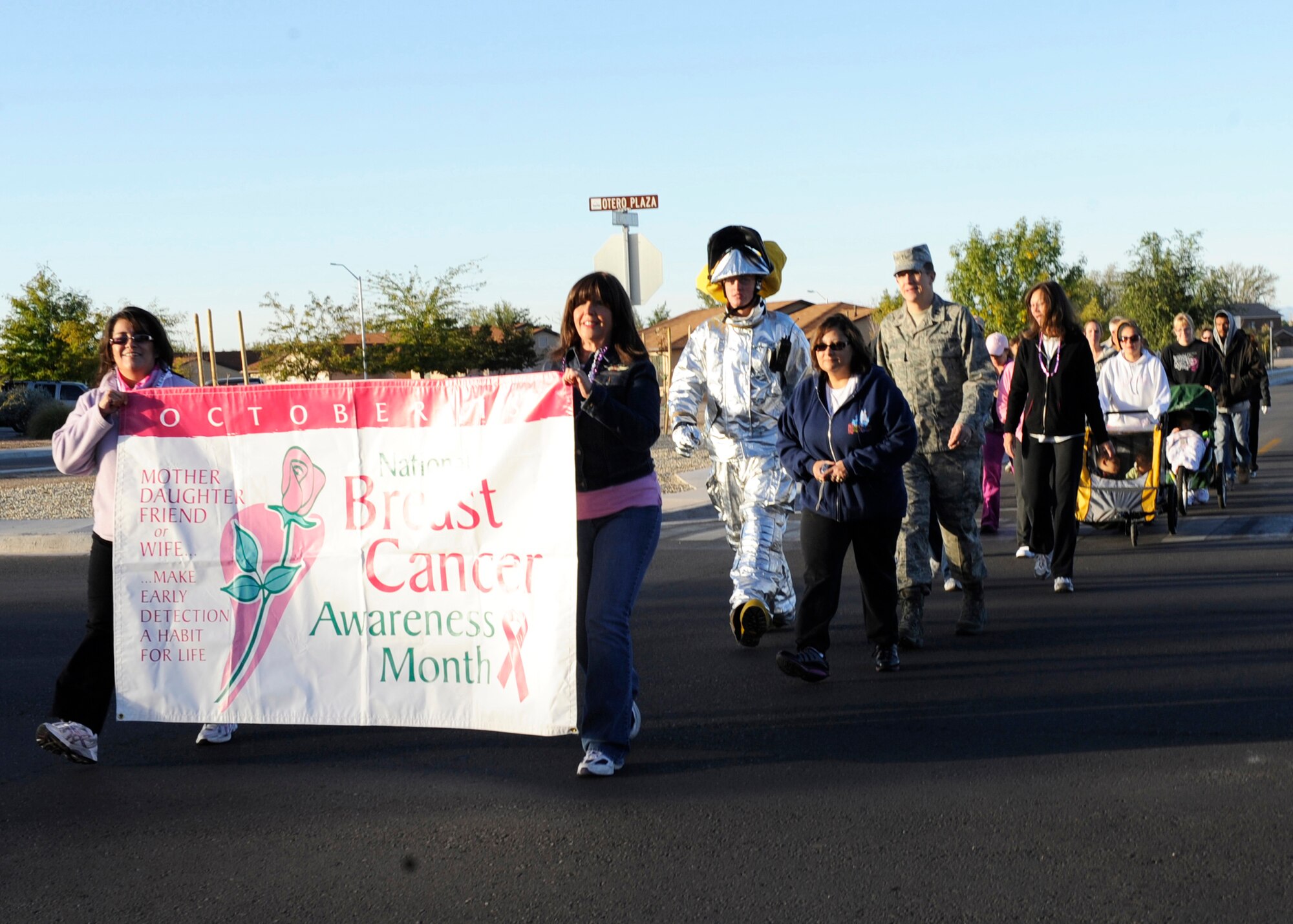 HOLLOMAN AIR FORCE BASE, N.M. -- Claudia Enriquez and Barbara Broughton, both members of the 49th Medical Group, lead the Annual Breast Cancer Awareness Walk-A-Thon through a neighborhood on base and down First Street Oct. 26, 2010. In honor of Breast Cancer Awareness Month, members of Team Holloman arranged a Breast Cancer Awareness Walk-A-Thon. Participants in the walk included Soaring Heights staff, spouses and dependants with the 49th Civil Engineer Squadron Fire Protection Flight lead the way in a fire truck and the 49th Security Forces Squadron directing traffic. The mission of the event was to reach out to the public to let them know that early detection is key in the treatment of breast cancer. (U.S. Air Force photo by Airman 1st Class Eileen Payne/Released)