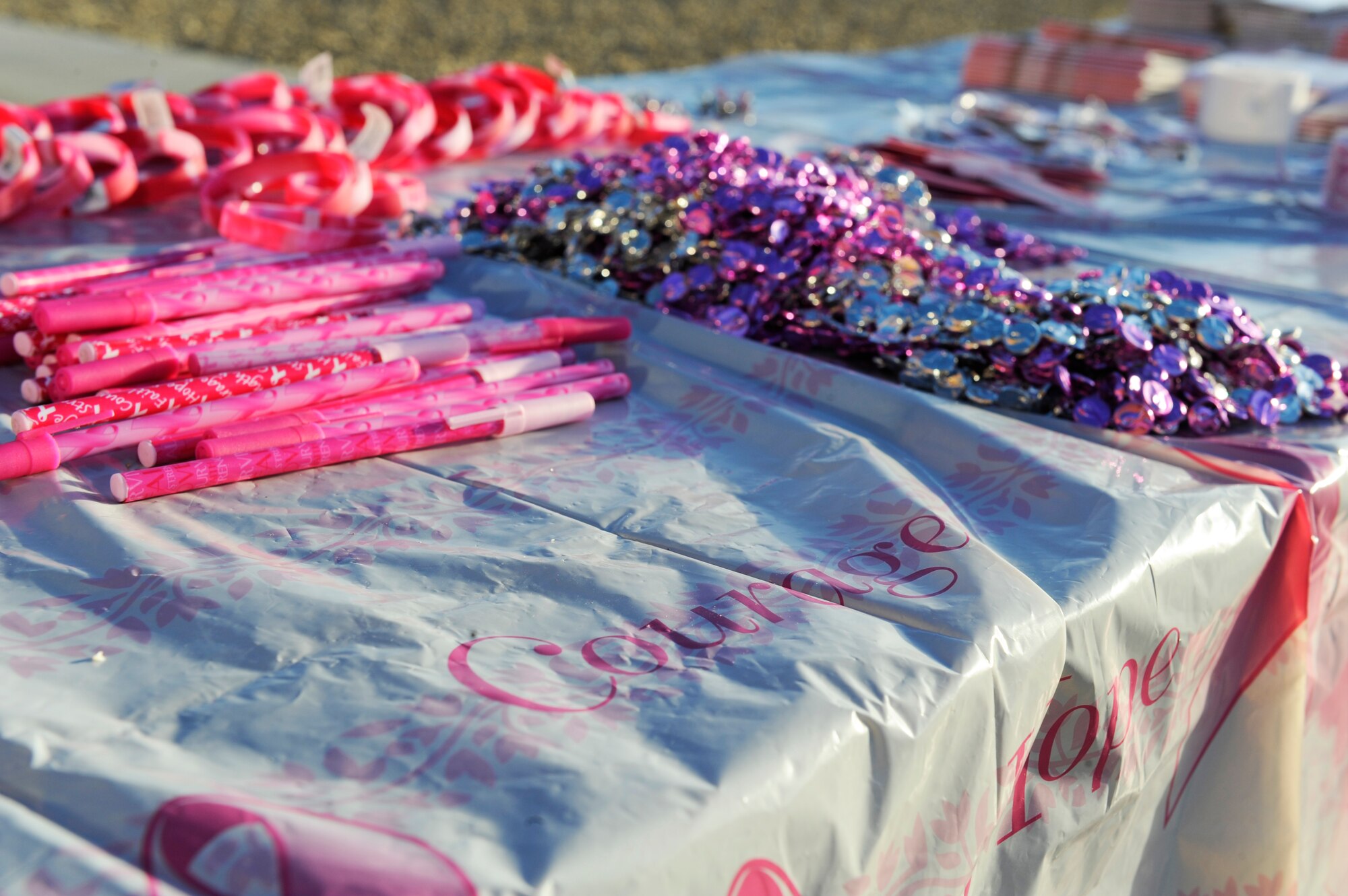 HOLLOMAN AIR FORCE BASE, N.M. -- Breast cancer awareness promotional merchandise, provided by the 49th Medical Group Health and Wellness Center, are laid out on a table in front of the Soaring Heights Welcome Home Center Oct. 26, 2010. In honor of the annual Breast Cancer Awareness Month, members of Team Holloman arranged a Breast Cancer Awareness Walk-A-Thon. Participants in the walk included Soaring Heights staff, spouses and dependants with the 49th Civil Engineer Squadron Fire Protection Flight leading the way in a fire truck and the 49th Security Forces Squadron directing traffic. The mission of the event was to reach out to the public to let them know that early detection is key in the treatment of breast cancer. (U.S. Air Force photo by Airman 1st Class Eileen Payne/Released)