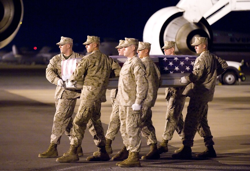 A U.S. Marine Corps carry team transfers the remains of Marine Staff Sgt. Joshua J. Cullins of Simi Valley, Calif., at Dover Air Force Base, Del., Oct. 21, 2010. He was assigned to the 1st Explosive Ordnance Disposal Company, 1st Marine Logistics Group, I Marine Expeditionary Force, Camp Pendleton, Calif. (U.S. Air Force photo/Jason Minto)