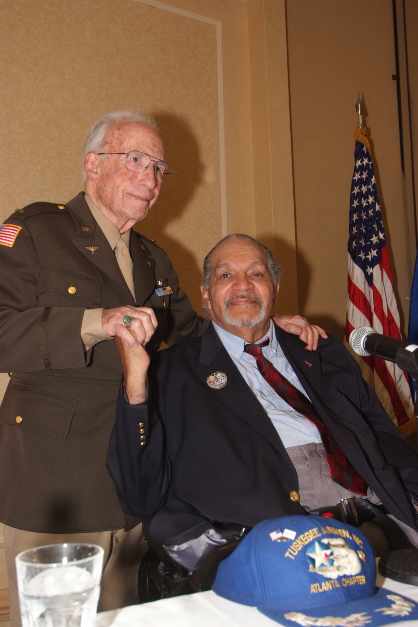 Former Flight Officer Herbert Heilbrun (left) and Tuskegee Airman Ray Williams share a moment after telling their history to over 350 airmen during the Air Force Reserve Command Human Resources Development Council conference  Oct 24-27, 2010 in Atlanta.  Heilbrun was a B-17 bomber pilot, escorted by Williams, a P-51 pilot.  The pair were reunited  50 years after their flights, only to discover that they went to school together 15 years before their military service.  (U.S. Air Force photo/Tech Sgt. Joe Zuccaro)