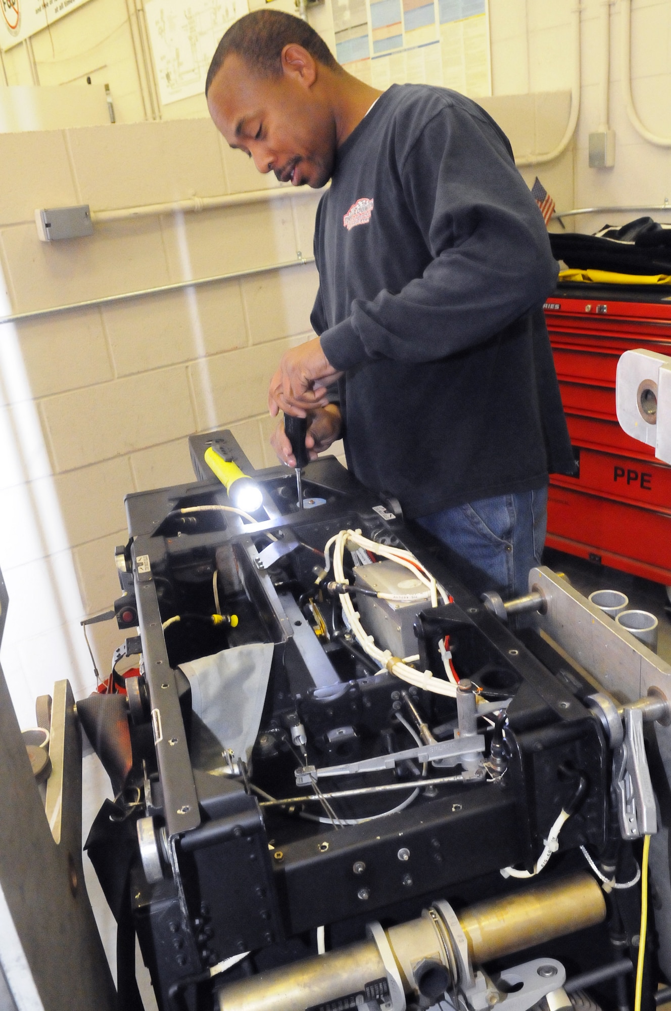 Gerald Reeves, aircraft ordnance systems mechanic, works on an F-15 ACES II egress seat. U. S. Air Force photo by Sue Sapp