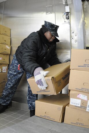 JOINT BASE CHARLESTON, SC (October 26, 2010) Donned with a heavy coat, gloves and ear-muffs, Culinary Specialist 2nd Class Lakisha Johnson stacks boxes of ribs in a 20-degree walk-in freezer at the Joint Base Charleston-Weapons Station, S.C., galley, Oct. 26, 2010. The highly acclaimed, five-time award winning five-star galley serves more than 2,000 Navy nuclear students and Sailors each day on board JB CHS-WS. CS2 Johnson is attached to Naval Support Activity on JB CHS-WS. (U.S. Navy photo/Mass Communication Specialist 1st Class Jennifer Hudson)