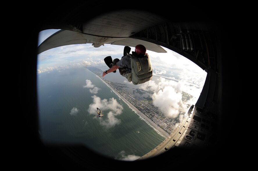 COCOA BEAFCH, Fla. - The City of Orlando, Known as America's playground and the endless summer sanctuary that is Cocoa Beach, have become staging spots for this year's Air Force Week, a culmination of recruiting magnificence that happens only twice a year at select locations. The first was in New York City earlier this year. Here a 920th Rescue Wing pararescuman from Patrick Air Force Base parachutes into the Atlantic Ocean of the coast of Cocoa Beach during a water rescue demonstratoin. (U.S. Air Force photo/Master Sgt. Rob Grande)