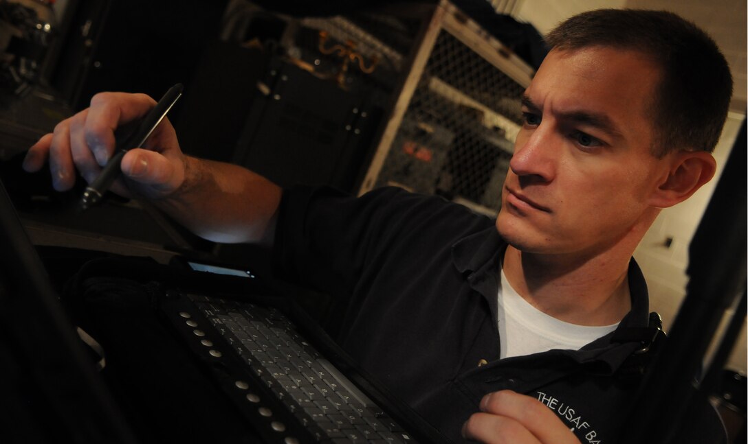 BALTIMORE -- Master Sgt. Mark Hannah, audio engineer in the U.S. Air Force Band, scans for open frequencies during a performance Oct. 22 at Northwestern High School, Baltimore, Md. The audio engineer designs and adjusts the audio product using electronics, before amplifying the final product for the audience. (U.S. Air Force photo by Air Force Senior Airman Christopher Ruano)