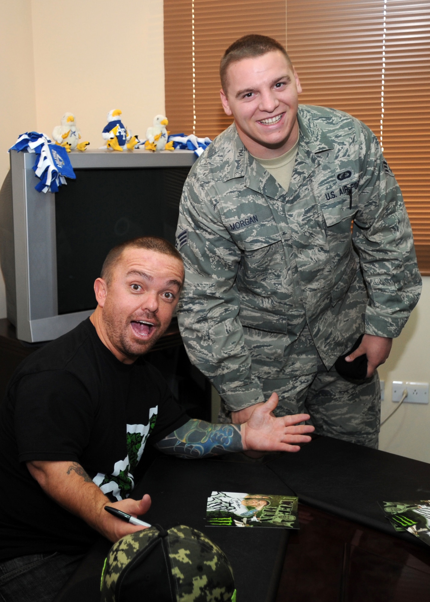 SOUTHWEST ASIA -- Actor Jason Acuña (left), who plays the role of Wee-Man in the movie "Jackass 3D," signs an autograph for Senior Airman David Morgan of the 386th Expeditionary Contracting Squadron during a visit to an undisclosed air base here Oct. 25, 2010. Acuña was visiting with troops as part of a promotional tour for the new movie. (U.S. Air Force photo by Senior Airman Laura Turner)