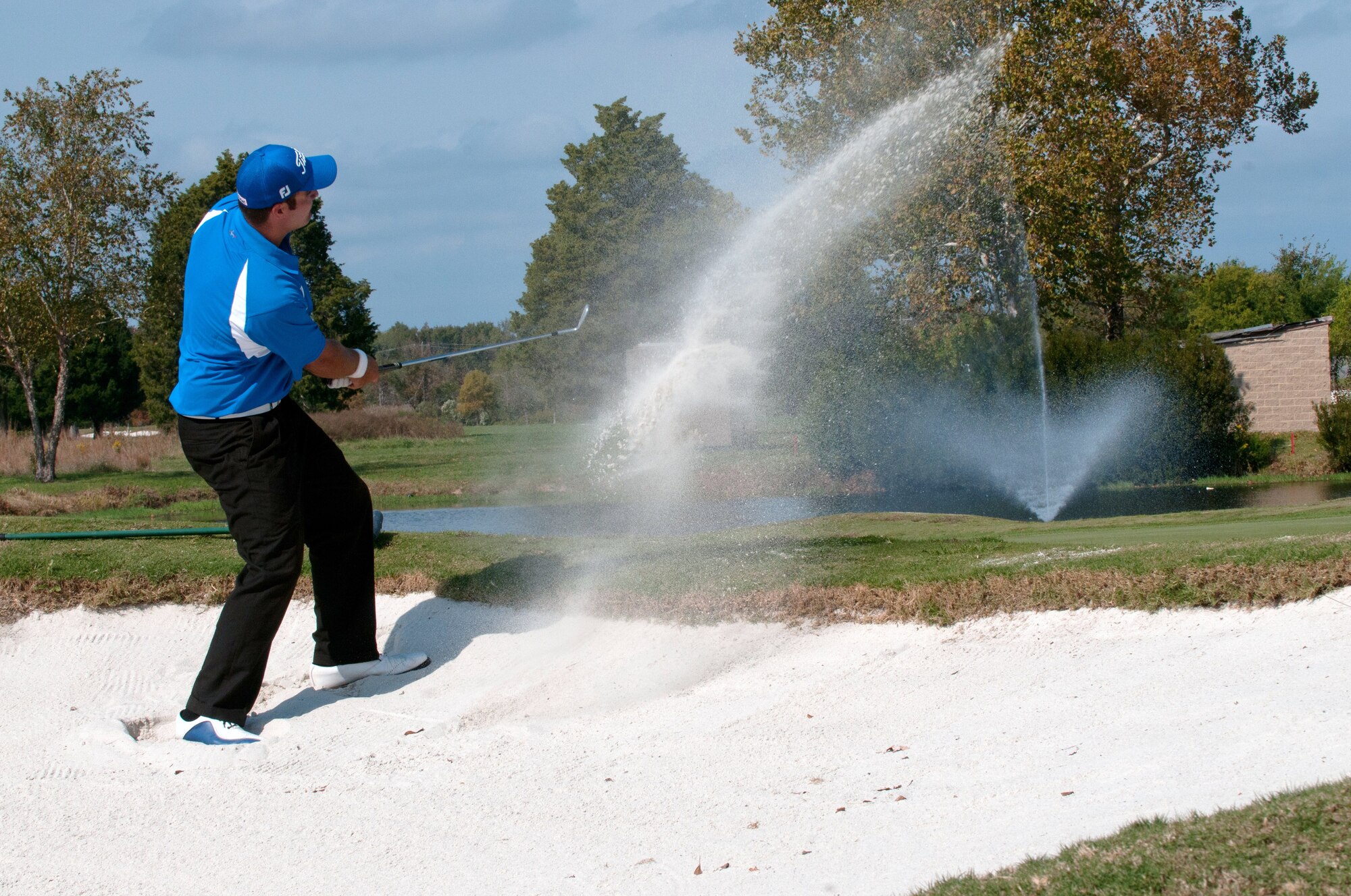 LANGLEY AIR FORCE BASE, Va. – U.S. Air Force golfer Thomas Whitney, of Vandenberg Air Force Base, drives the ball from a sand bunker during the Air Force Golf Championship Oct. 19. Air Force personnel from around the world competed in the tournament to advance on to the Armed Forces Golf Championship. At the conclusion of the Armed Forces competitions, the best players are selected to represent the U.S. at International Military Sports Competitions hosted worldwide or at U.S. national championships. (U.S. Air Force photo/Eric Deagle)