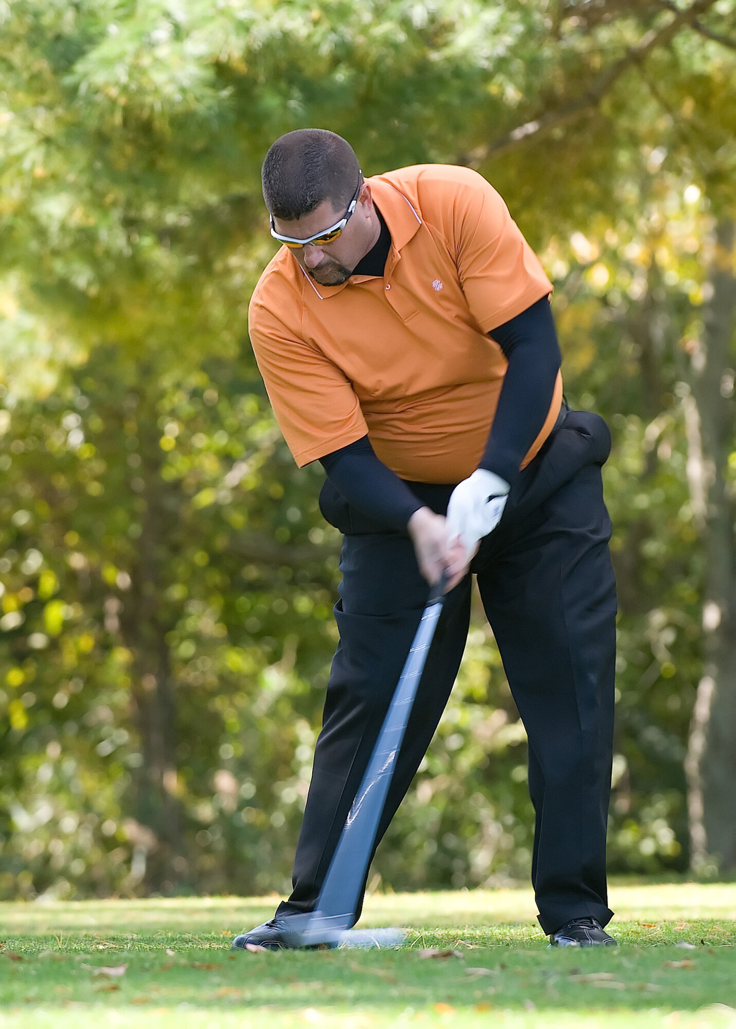 Richard Barker, 436th Security Forces Squadron, sets up a swing at a golf tournament during Fall Wing Sports Day at the Eagle Creek Golf Course, Dover Air Force Base, Del., Oct. 22, 2010. Fall Wing Sports Day allowed many people to participate in a wide range of sporting events, such as golf, ping pong, dodge-ball, volleyball, softball and others. (U.S. Air Force photo by Jason Minto/Released)