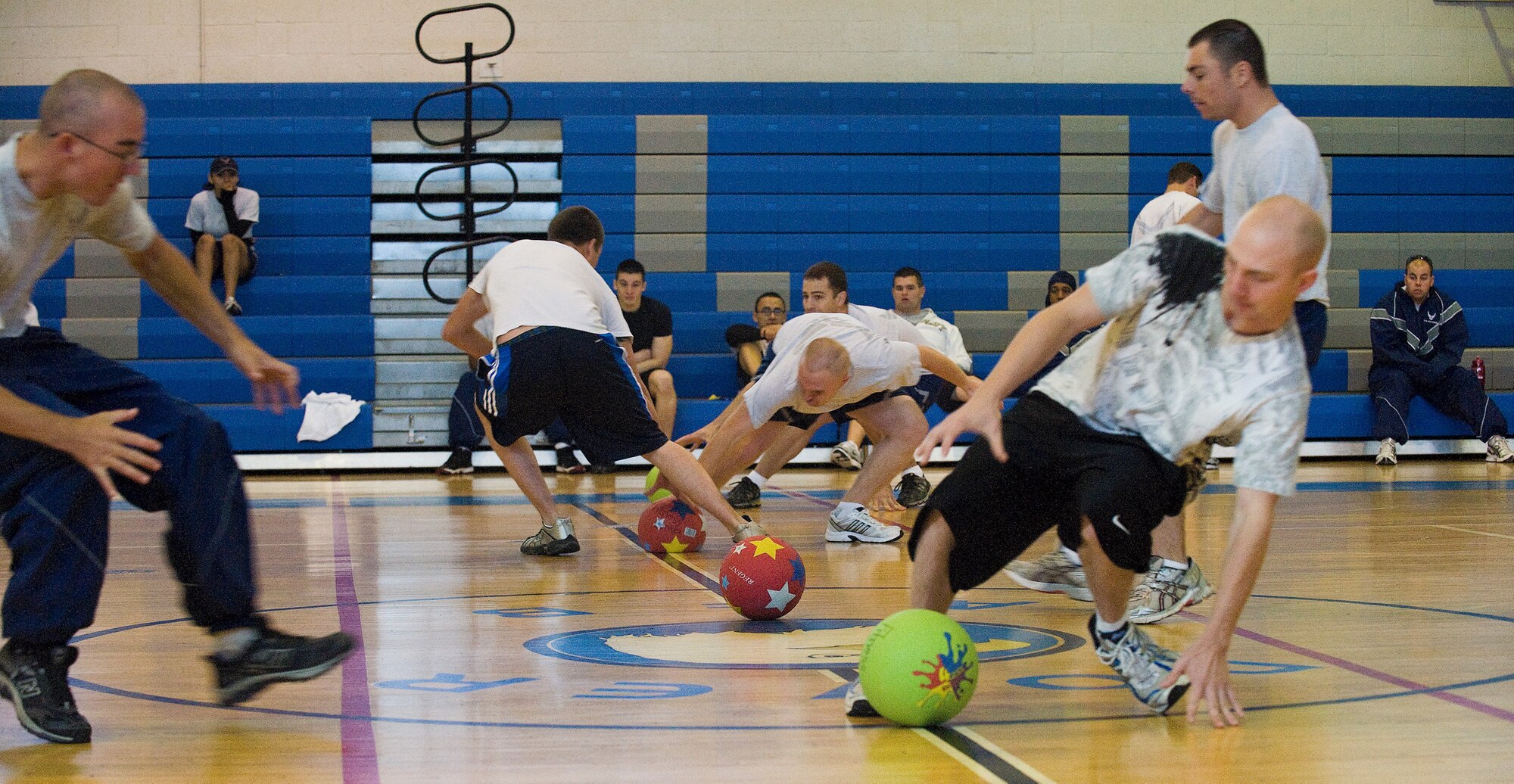 Team Dover members play during a dodge-ball tournament during Fall Wing Sports Day at the Fitness Center, Dover Air Force Base, Del., Oct. 22, 2010. The dodge-ball tournament consisted of different squadron teams of five, trying to place players out of play by hitting them with the ball. (U.S. Air Force photo by Roland Balik/Released)