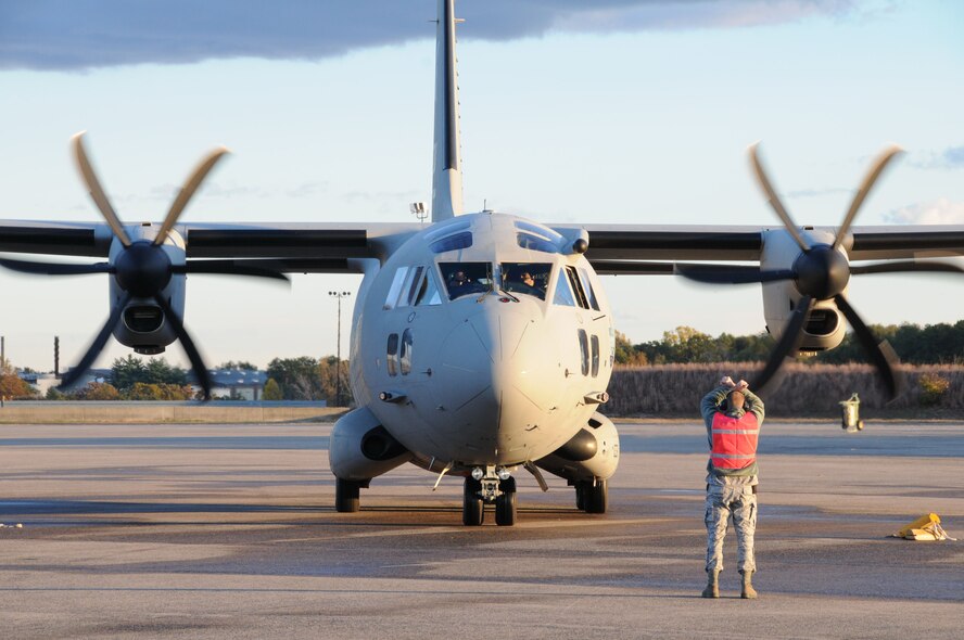 Tech. Sgt. Jonathan Favreau, aerospace maintenance craftsmen, 103rd Aircraft Maintenance Squadron, marshals in a C27J Spartan for the first time at Bradley Air National Guard Base in East Granby, Conn. on Thursday, Oct. 21, 2010.  The aircraft visit afforded the Flying Yankees of the 103rd Airlift Wing an opportunity to experience its future mission capabilities first hand.  (U.S. Air Force photo by Tech. Sgt. Erin E. McNamara)