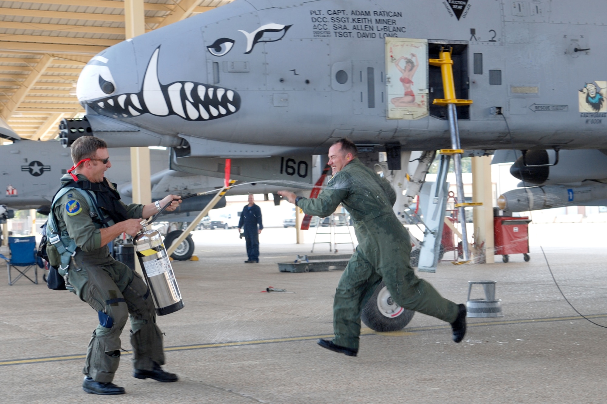 Capt. Adam Ratican, a 47th Fighter Squadron instructor pilot, goes after Capt. Jason Cobb, 47th FS instructor pilot, after being wet down upon returning from his final flight with the squadron on Oct. 19, 2010, at Barksdale Air Force Base, La. (U. S. Air Force Photo/Master Sgt. Greg Steele)